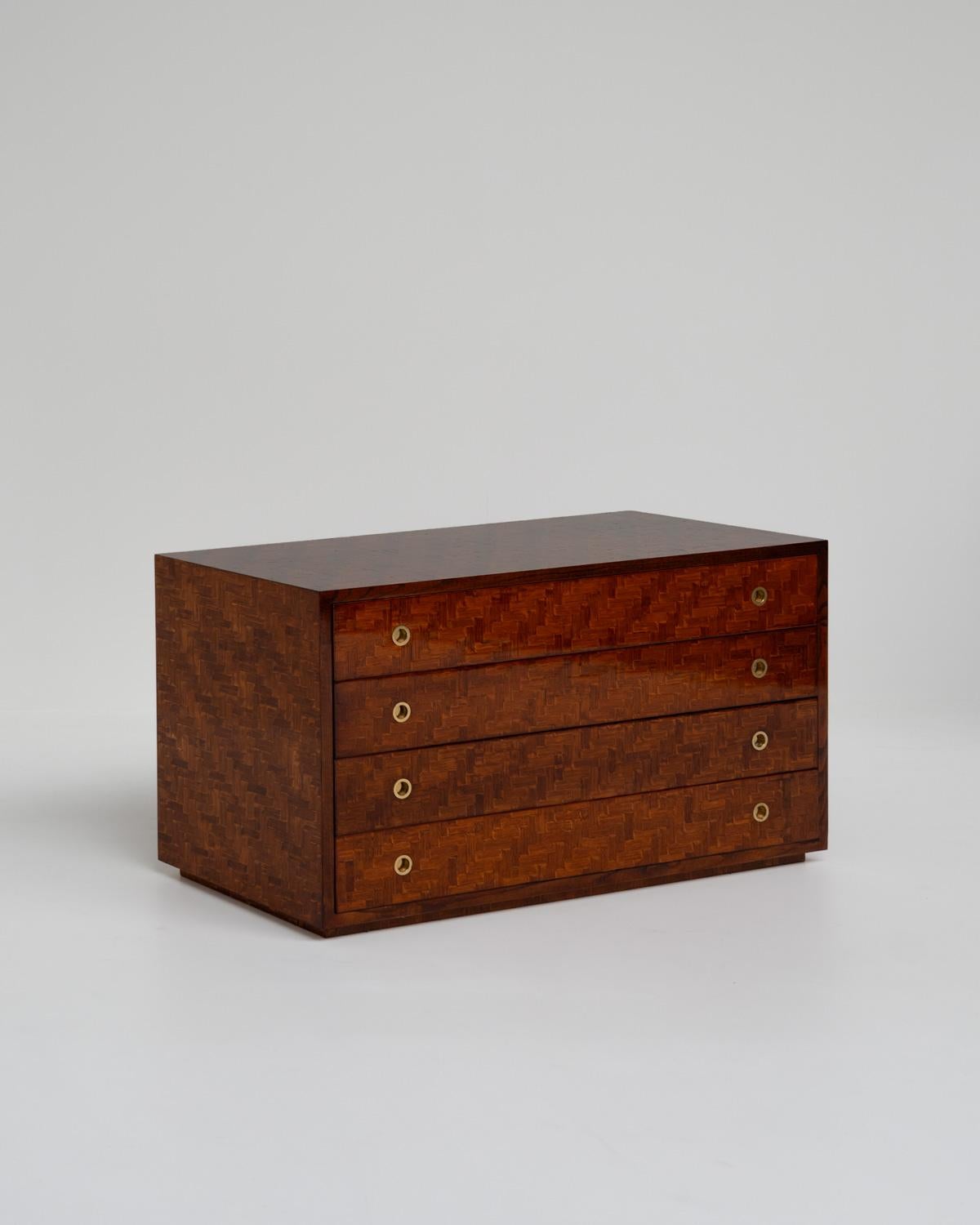 This bamboo chest of drawers oozes refined elegance that enhances any space. The dark-stained bamboo is accented by brass details, creating a beautiful contrast that catches the eye. This piece invokes nostalgia for a time of sophistication and