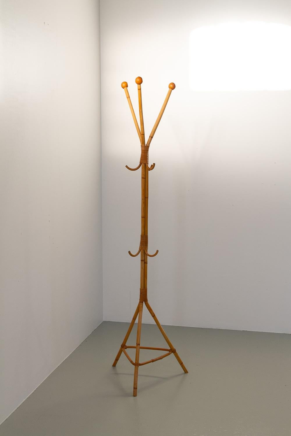 Italian Bamboo Coat Stand, 1960s.

Mid-Century Modern freestanding coat rack in bamboo and rattan made in Italy in the 1960s.
This lovely three-legged coat stand is fairly narrow and doesn't take up much space. Six hooks and three arms. Decorative