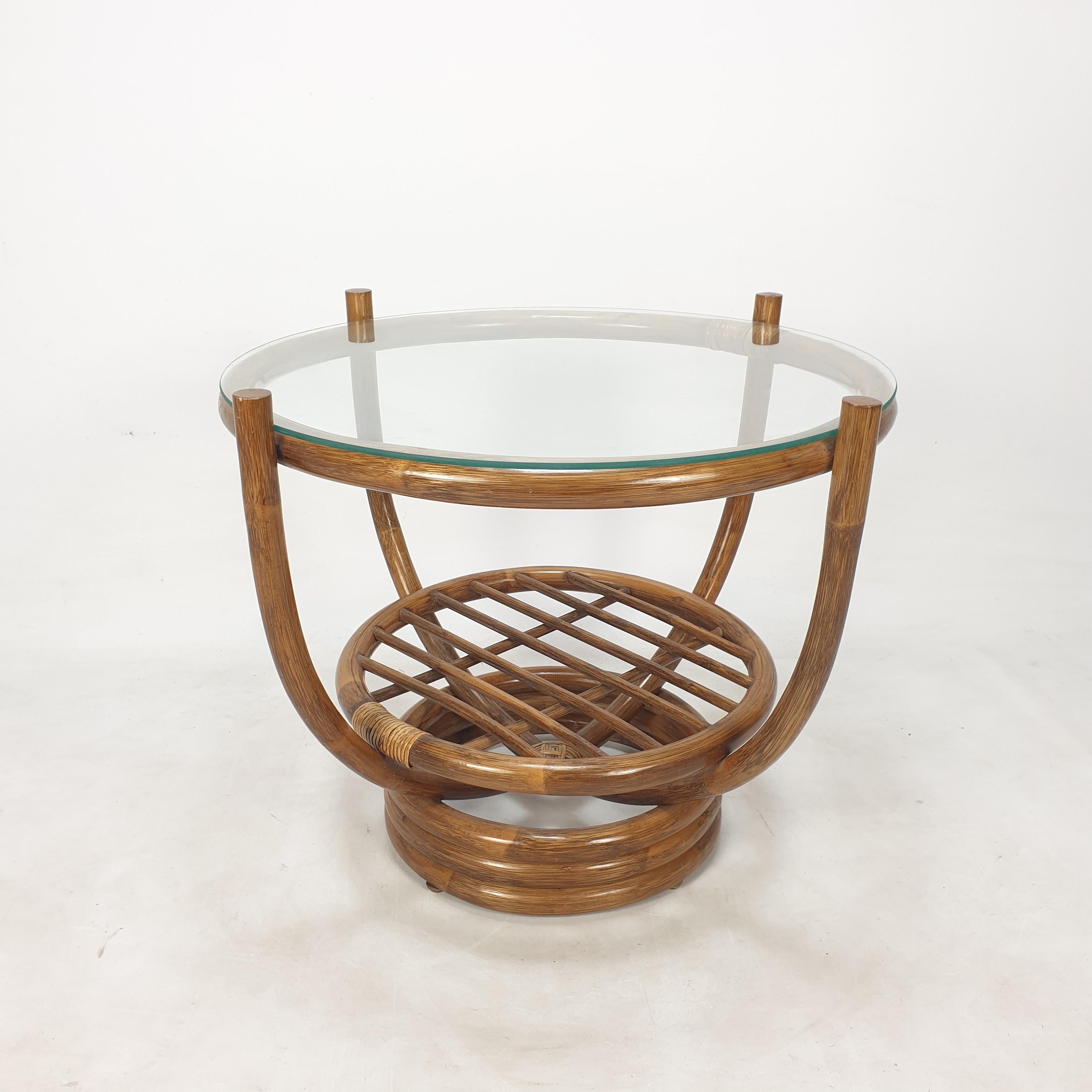Lovely coffee table, fabricated in Italy in the 80's. 
This very nice table is made of bamboo, the plate is of glass.