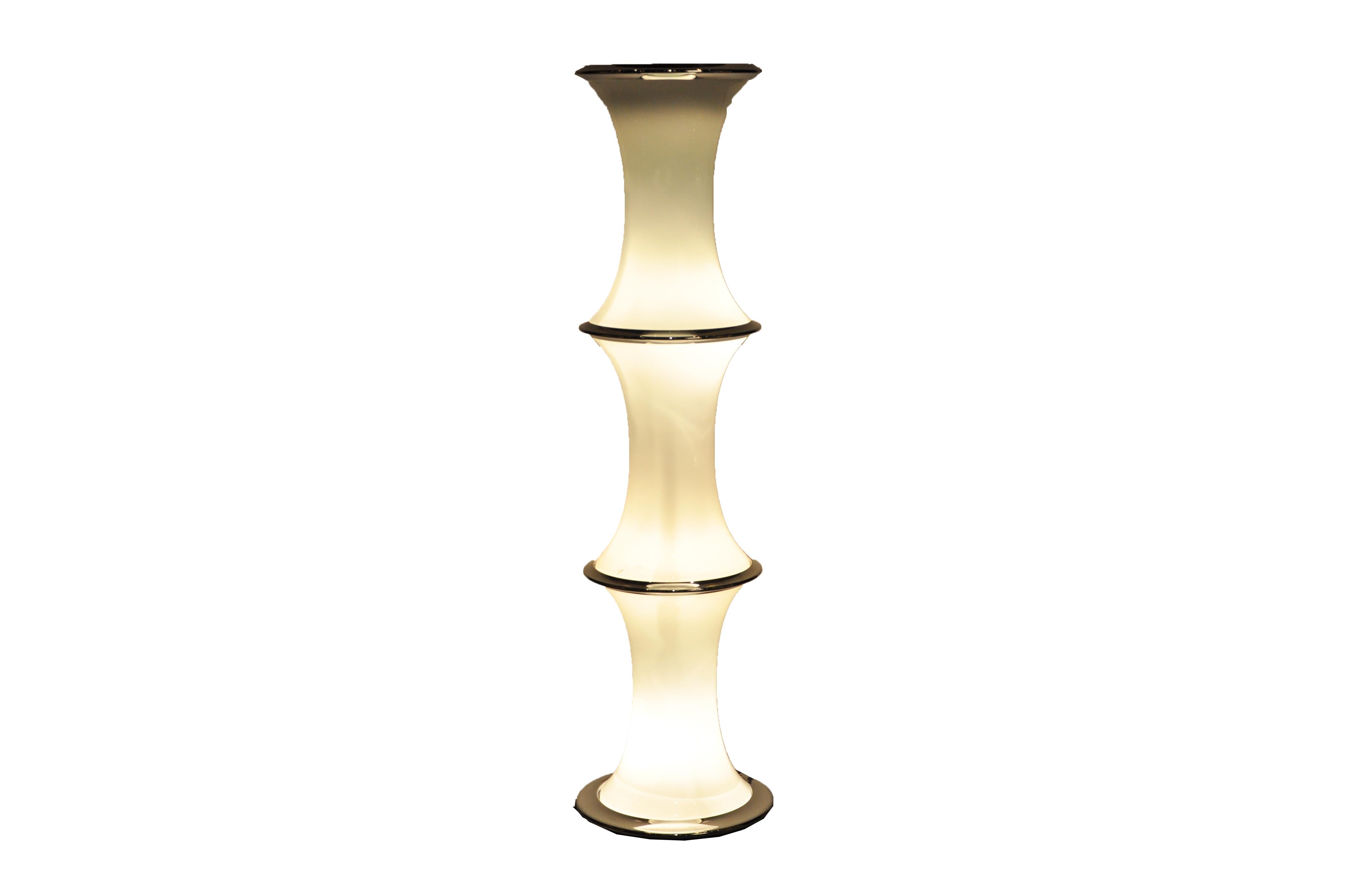 This unique bamboo-form floor lamp is from Murano, Italy and was made from chrome and glass, circa 1970. The lamp has been rewired for use in the U.S. It features interior lamps three interior bulbs and one upper bulb with a chrome dome. The piece
