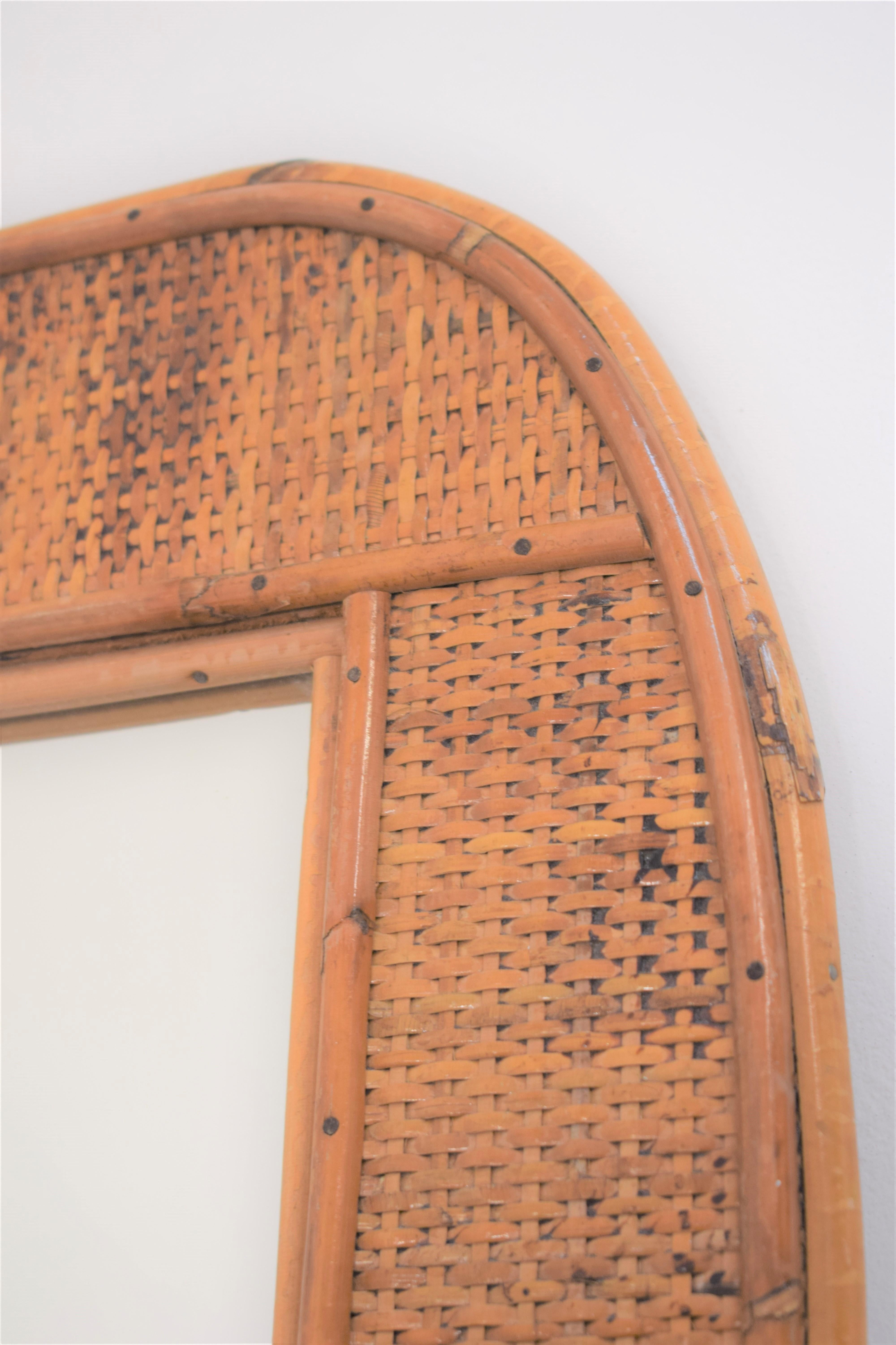 Italian bamboo wall mirror, 1960s.

Dimensions: H= 60 cm; W= 44 cm; D= 2 cm.