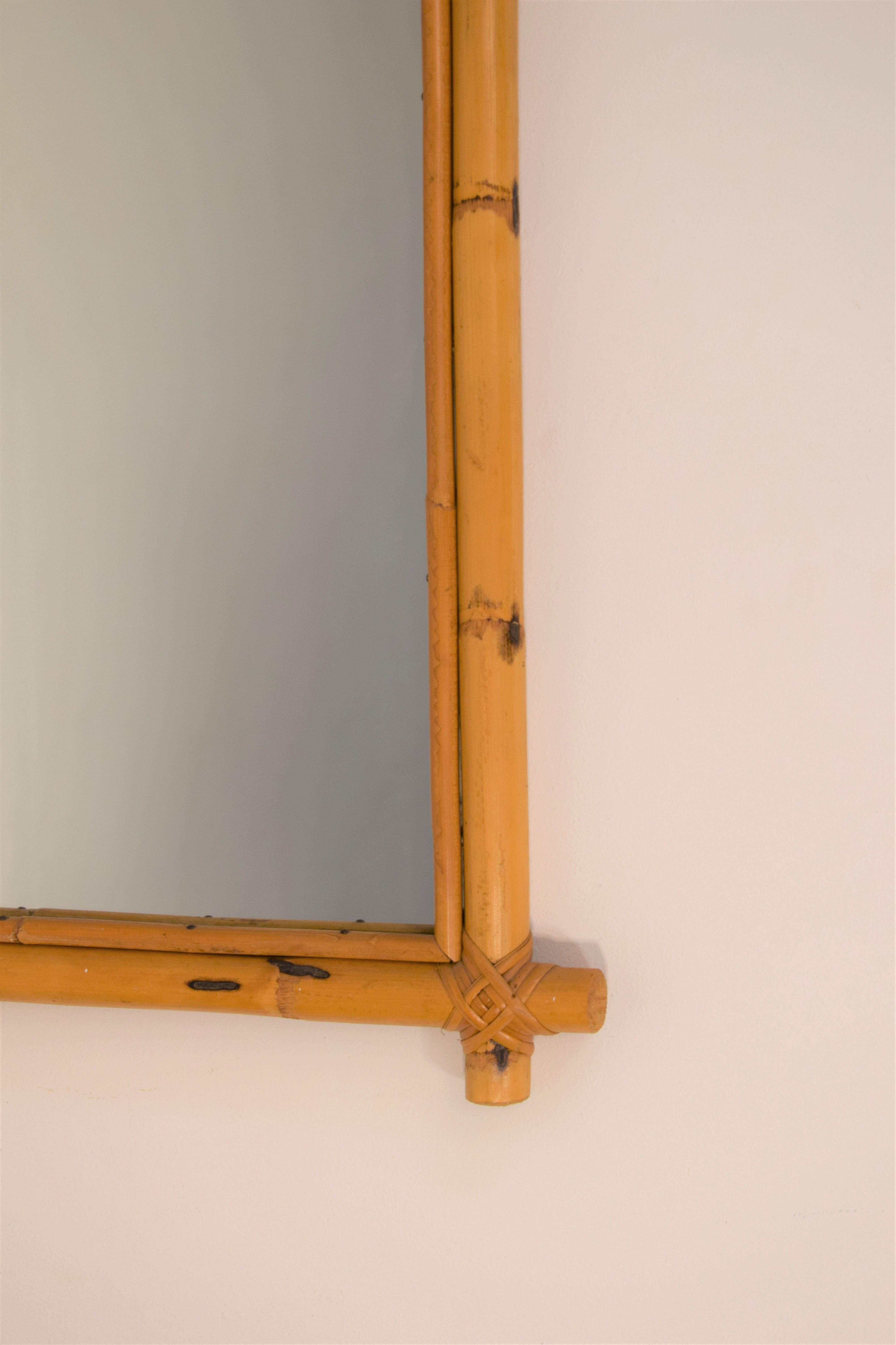 Italian bamboo wall mirror, 1960s.
2 available.
Dimensions: H= 82 cm; W= 46 cm; D= 3 cm.