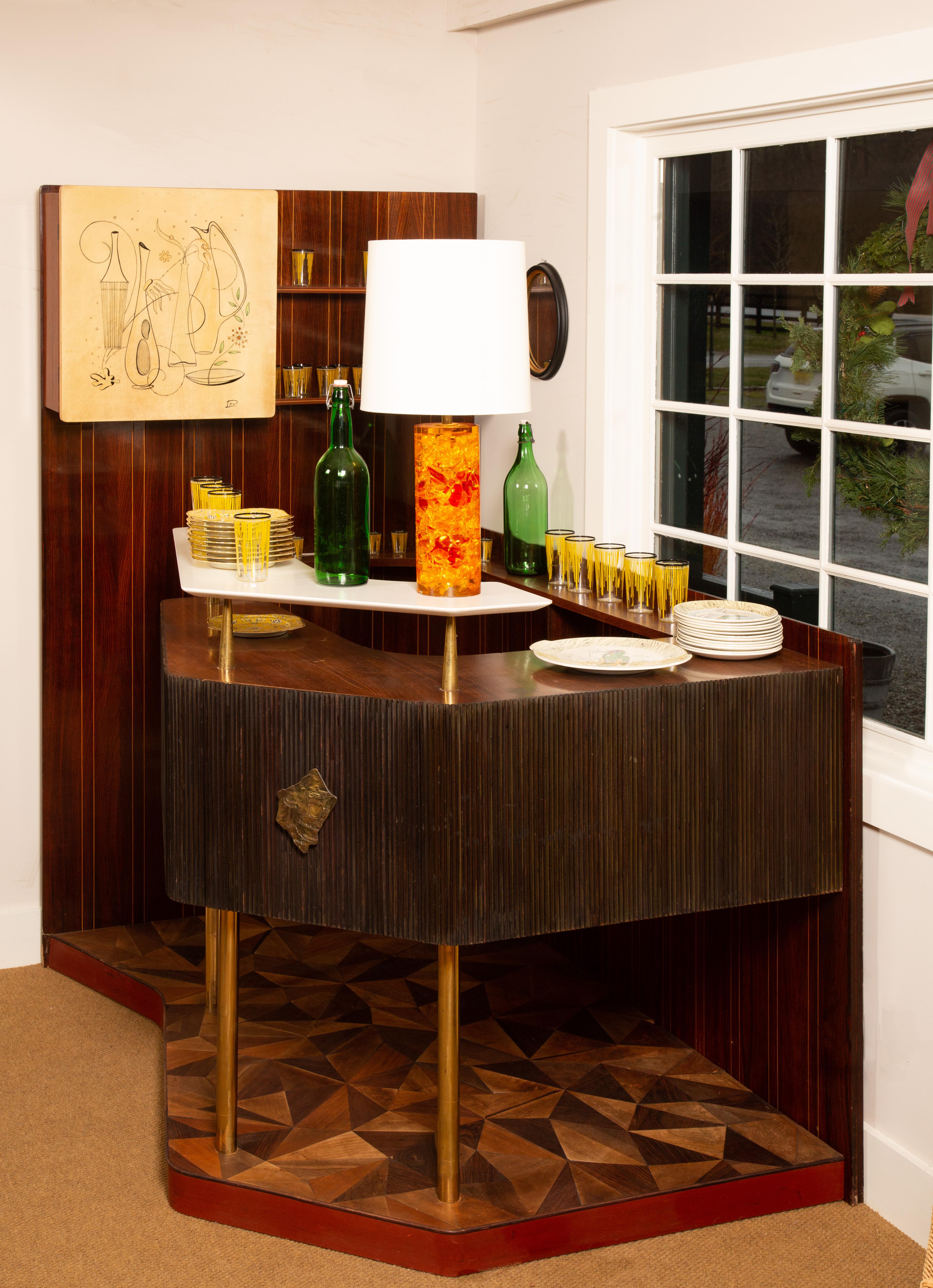Rare high-style Italian drybar cabinet made by La Permanente Mobili Cantu in the 1950s. The drybar is made of Macassar wood veneer and features a modernist graphic design on the door of the cabinet, which is used to store decanters and bottles. The