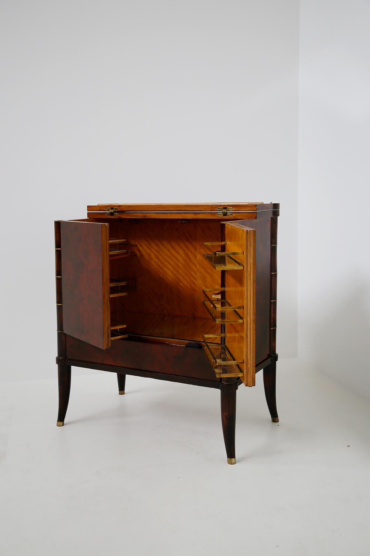 Rare and magnificent bar cabinet designed by Tomaso Buzzi, circa 1930. Verified by the Tomaso Buzzi foundation archive. The cabinet was designed on commission by a private Milanese house. The cabinet has a double hinged door. Inside we find in the