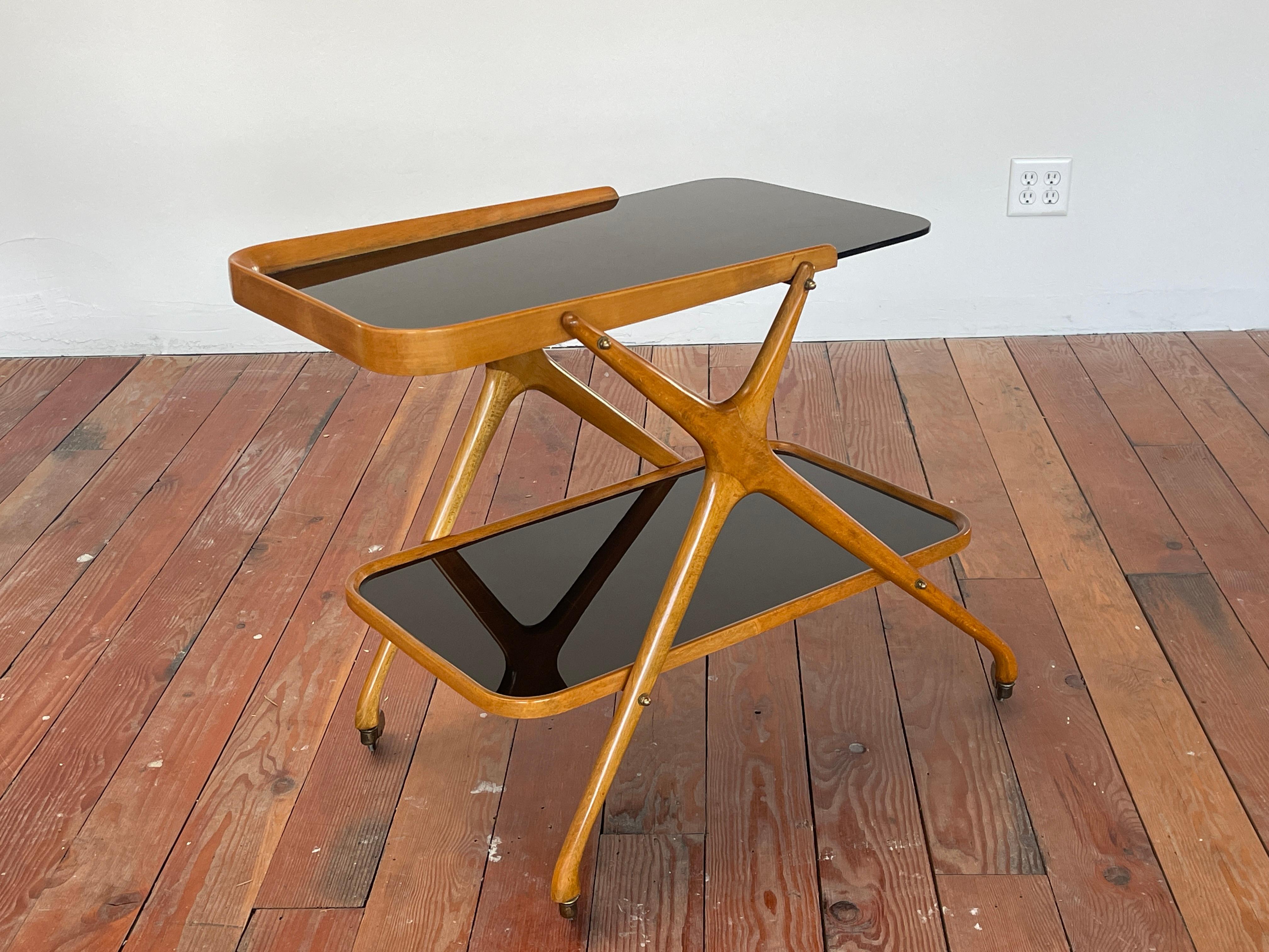 Handsome Italian bar cart with angular maple wood frame and original smoked black glass. 
Wonderful patina, original casters
Italy, circa 1950s.
 