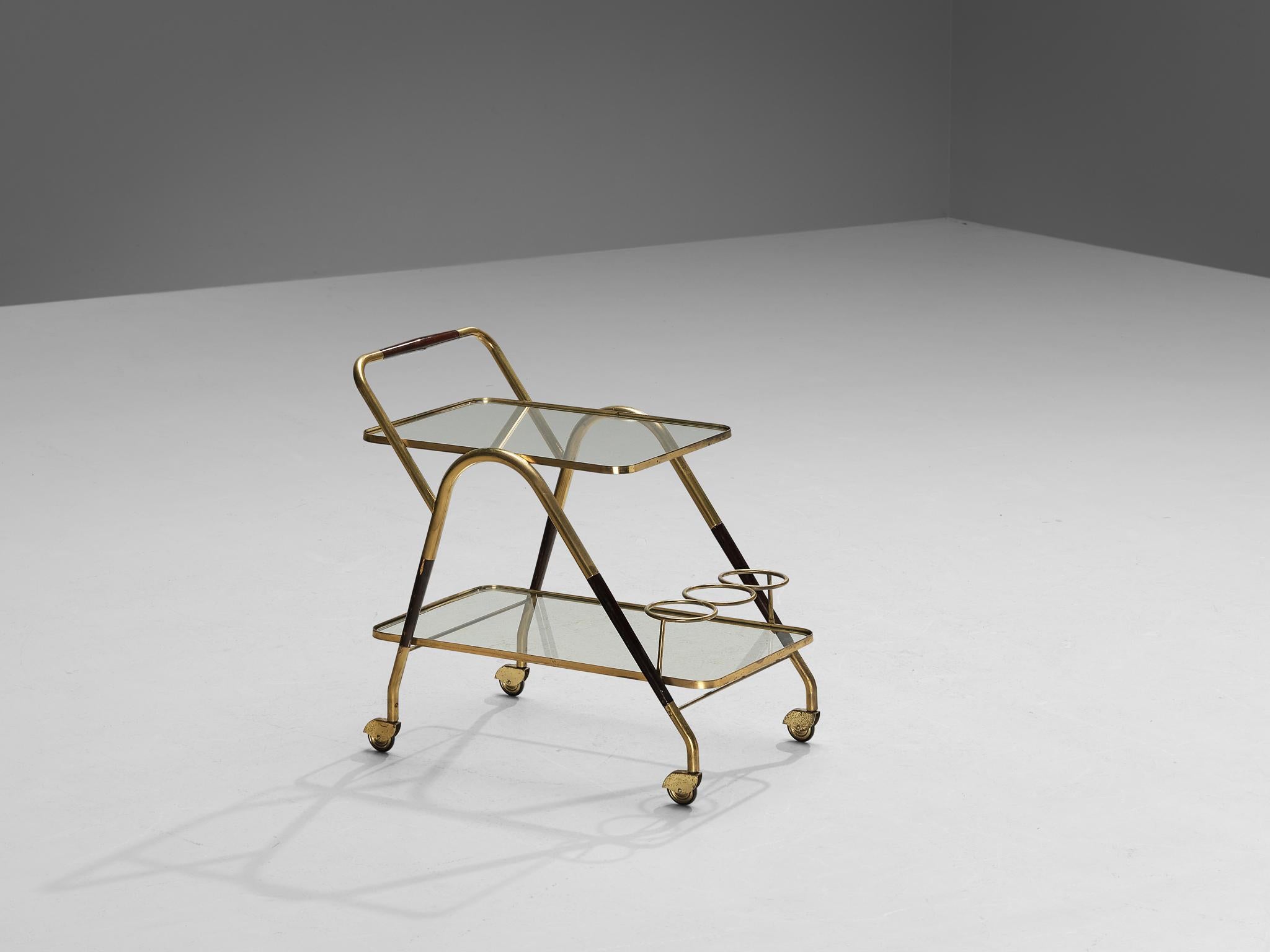 Bar cart, wood, brass, glass, Italy, 1950s

Elegant Italian serving trolley or liquor cart. The whole construction of this serving trolley is based on clear lines and round edges. Two glass trays establish plenty of space to serve your meals or