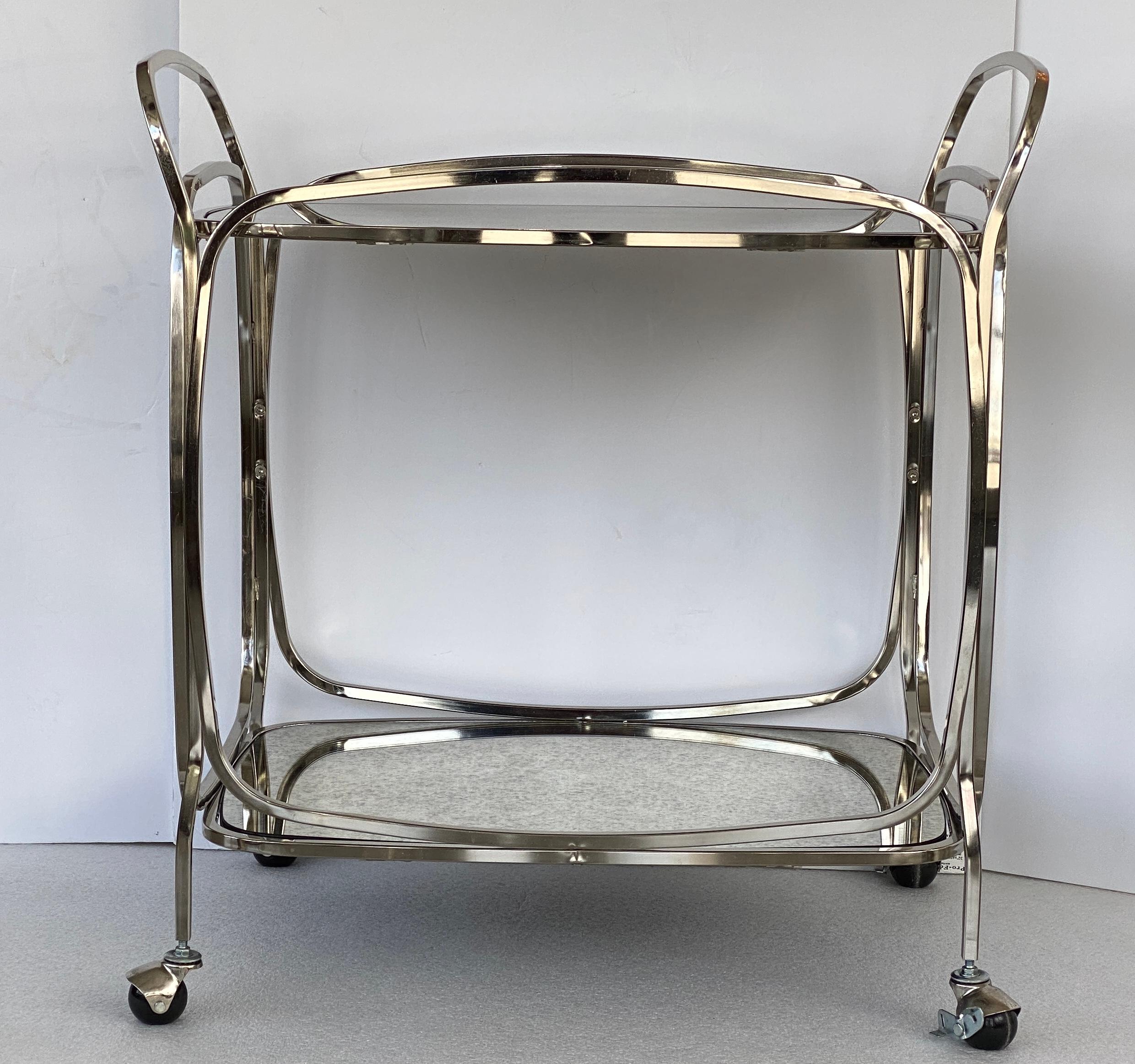 This stylish Mid-Century Modern style bar cart with its clean lines, stainless steel and antiqued mirror finished will make a subtle statement.

Note: The mirrors have some minor surface marks.

 