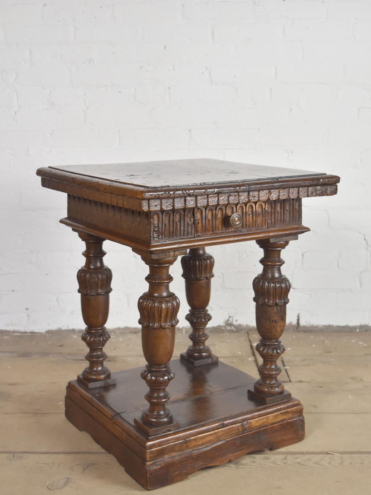 Exquisite small Italian table of square form, the top with a dentil decorated molded edge above a carved frieze containing a later constructed drawer, on four beautifully sculpted legs connecting a reconstructed platform base.