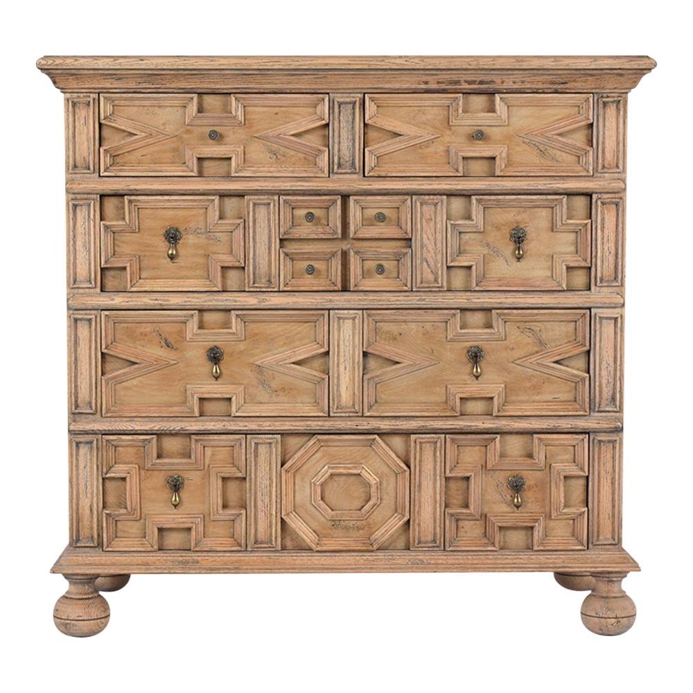 This 1980s Italian Baroque chest of drawers is made out of oak wood and burl veneers with a newly bleached finish and has been fully restored. This piece features a carved wooden top, four drawers with symmetric design, molded paneling, and comes