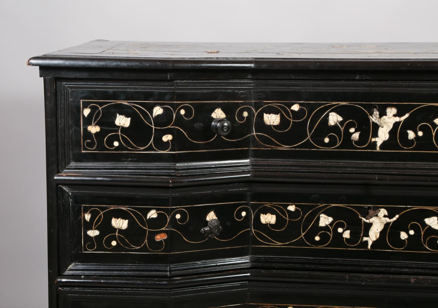 Very fine 17th century Italian, possibly Milanese, ebony commode inlaid with etched bone floral and figural decoration, the top drawer fitted as a secretary with walnut and fruitwood inlay and original wrought iron hardware, the case with concave