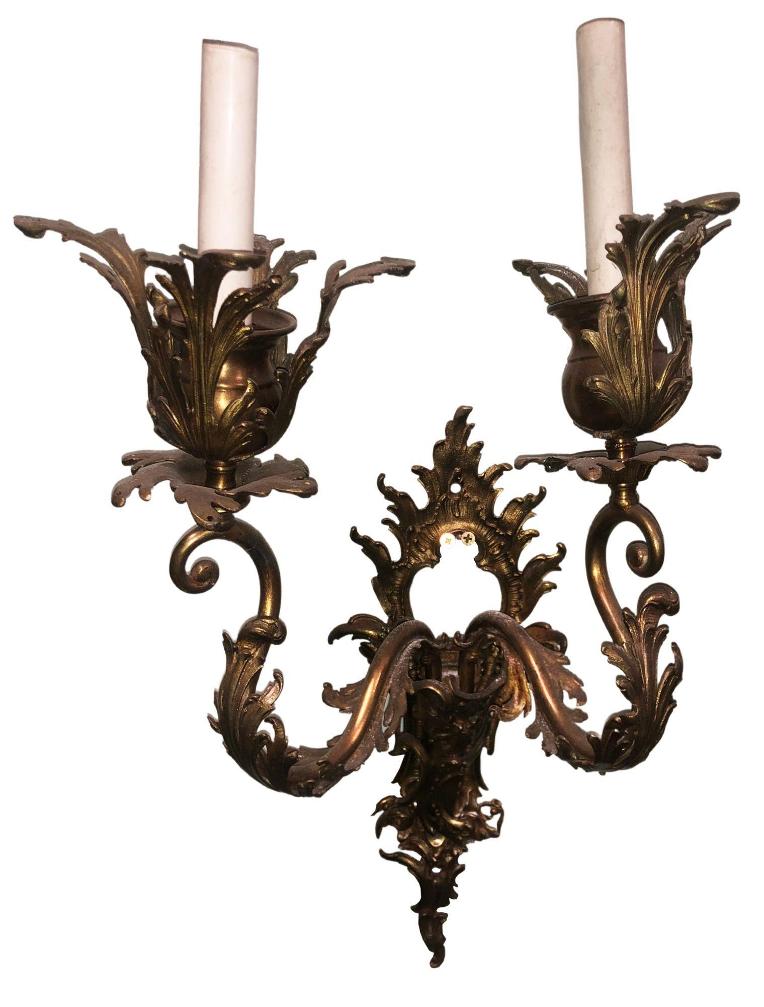 Discover opulence with this exquisite Antique Italian Baroque-style bronze candelabra wall sconce, now available for sale. This ornate piece evokes the grandeur of the Baroque era, with intricate detailing and multiple candleholders. Its timeless