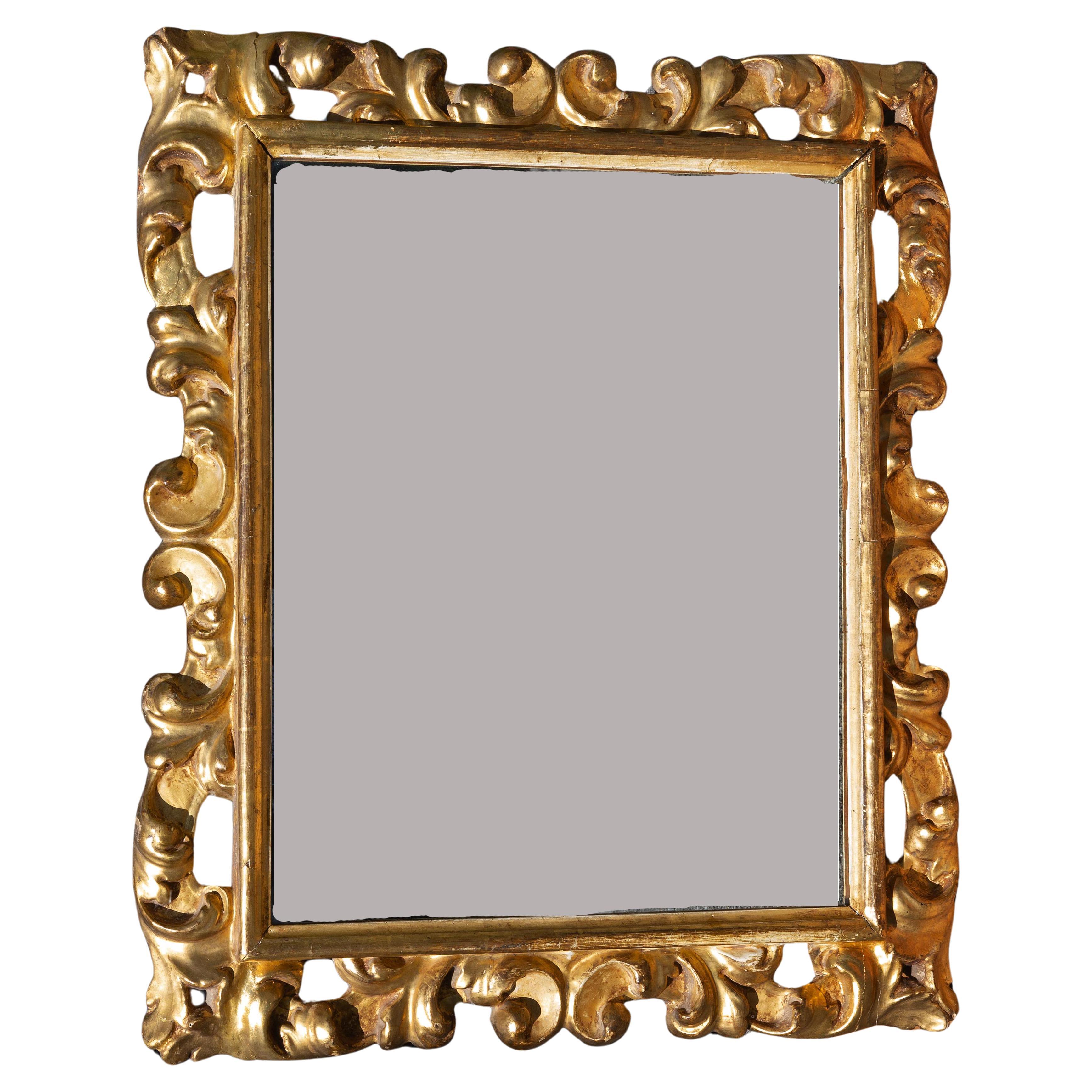 18th century Italian baroque style mirror. Hand carved with gold leaf gilding. 