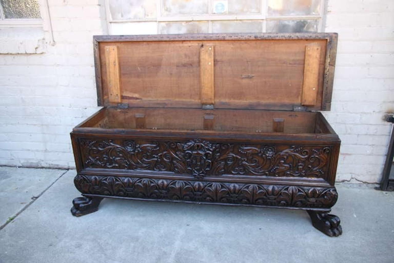 19th century walnut carved cassone with front lion feet.