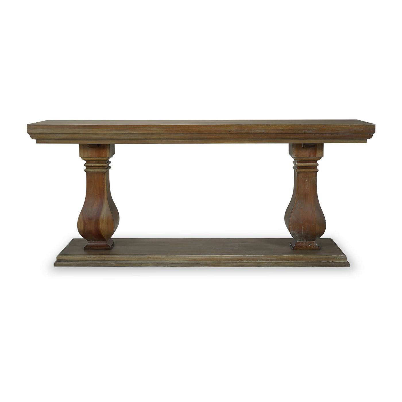 Crafted from solid mahogany, this table features bold baluster form pedestal legs that capture the opulent style of Baroque design. The rich, straw wash finish adds a touch of sophistication and warmth, making it an exquisite centerpiece for your