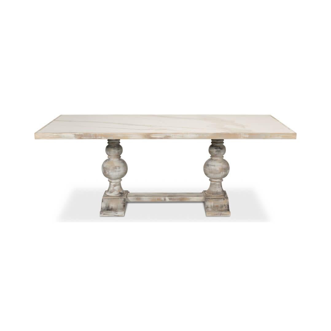 With an inlaid porcelain top that provides a sophisticated and easy to clean surface that is perfect for almost any occasion. Supported by a robust wooden trestle end base, with turned baluster supports in a distressed gray oak finish that adds a
