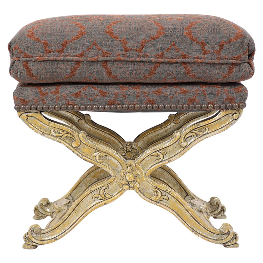 An eye-catching Italian Baroque style bench is crafted out of maple wood with its original gilt finish and has been newly restored by our team of craftsmen. The stool is upholstered in pattern design fabric with brass nail accents and topstitch