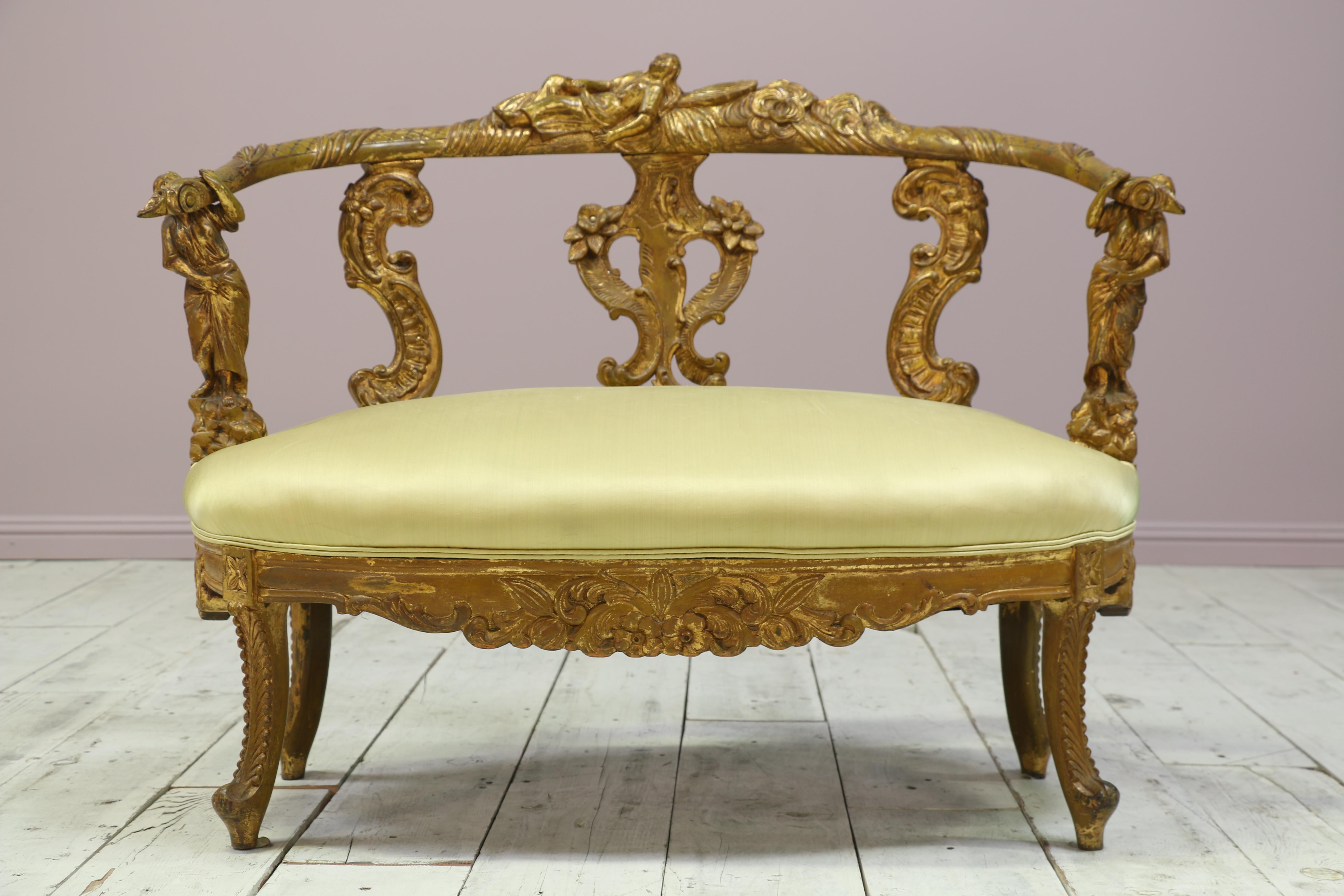 Beautiful antique Italian early 19th century carved giltwood settee and chair in the Baroque style. The chairs feature a finely carved whimsical theme including maidens, clouds, flowers and shells. Some of the flowers feature original encrusted