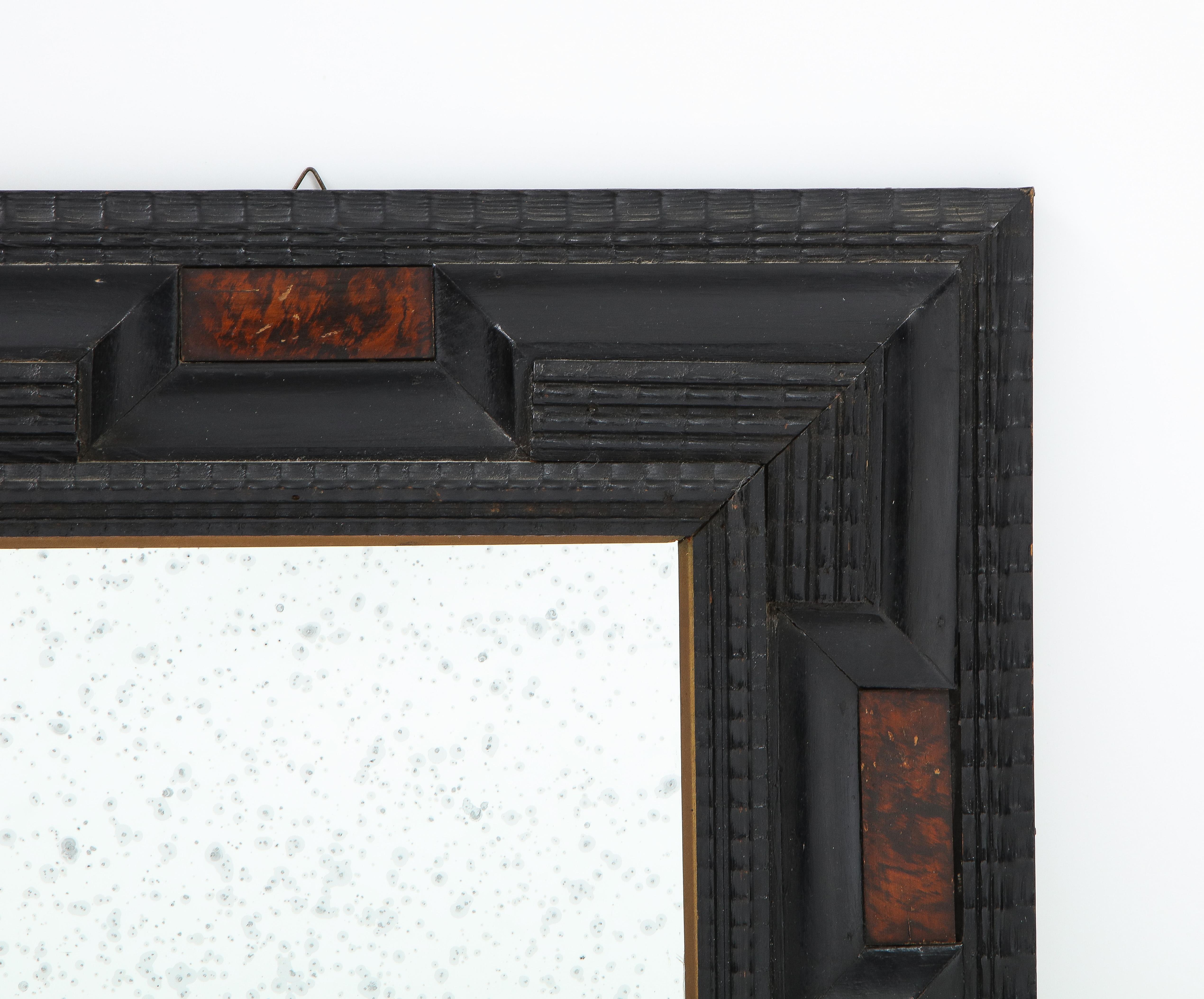 Northern Italian Baroque manner ebonized frame with faux tortoise plaques inset on each side, with antiqued mirror glass. Can be hung vertically or horizontally. 
Northern Italy, circa 1900 
Size: 17 1/4