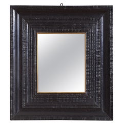 Italian Baroque Period Ebonized Guilloche Carved Mirror with Gilded Rabbet