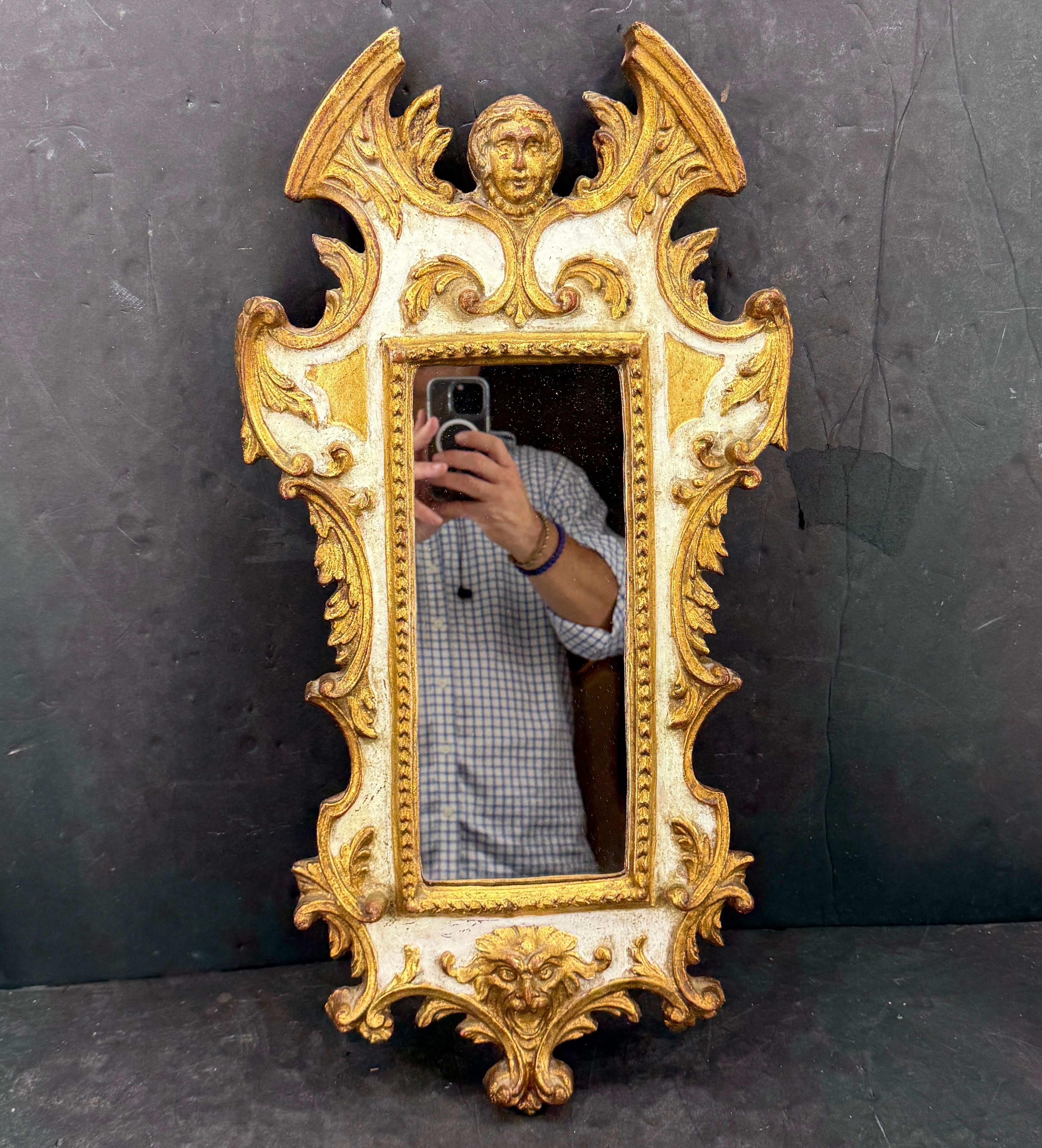 Late 19th Century Italian Baroque-Style Gilded Wall Mirror. Elegant carved wall mirror characterized by elaborate decorations including Italian putti's. This mirror is a very versatile piece that could be displayed in a foyer, living room, bedroom