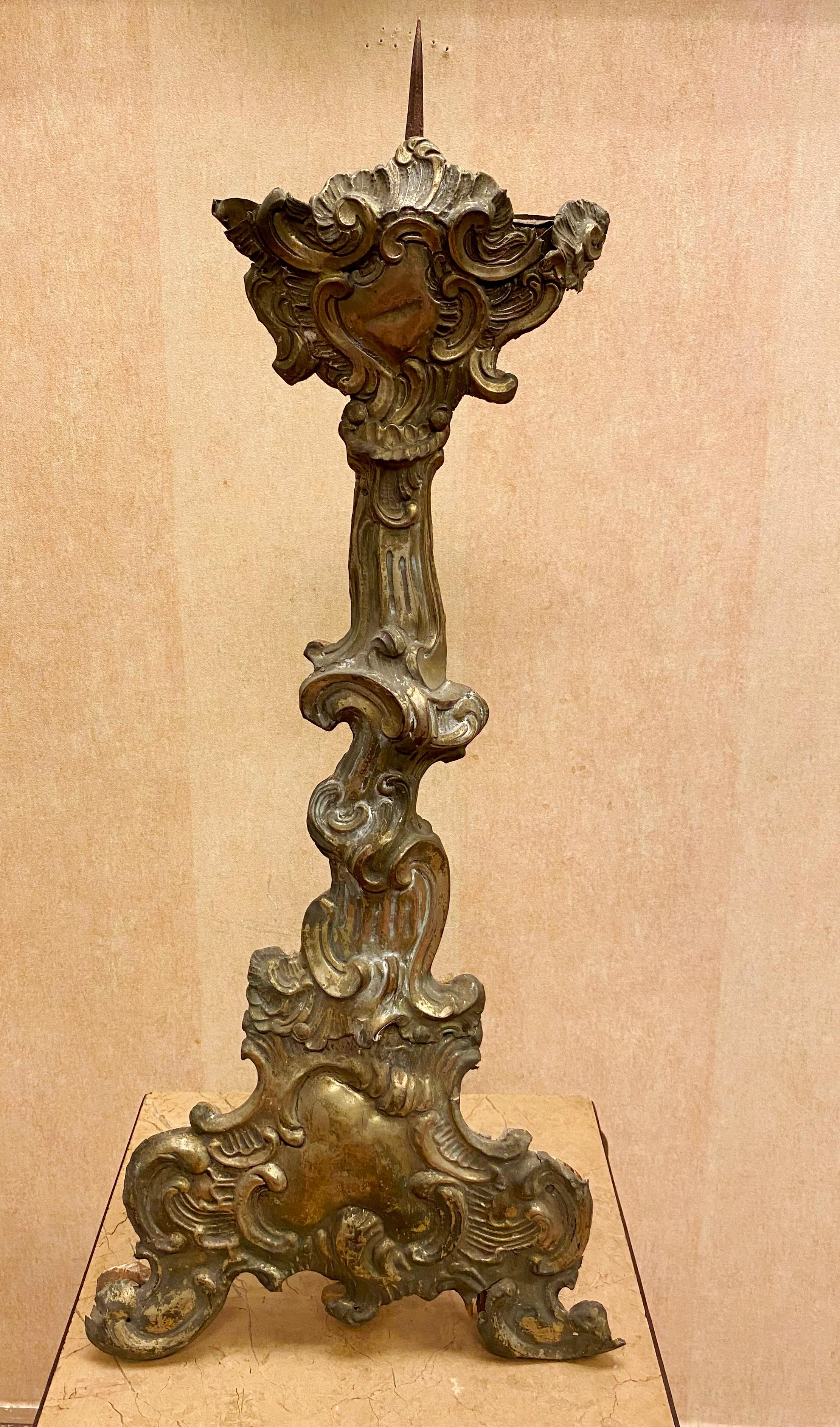 Italian Baroque pair of wood altar candlesticks with repousse silver fronts, 18th century.