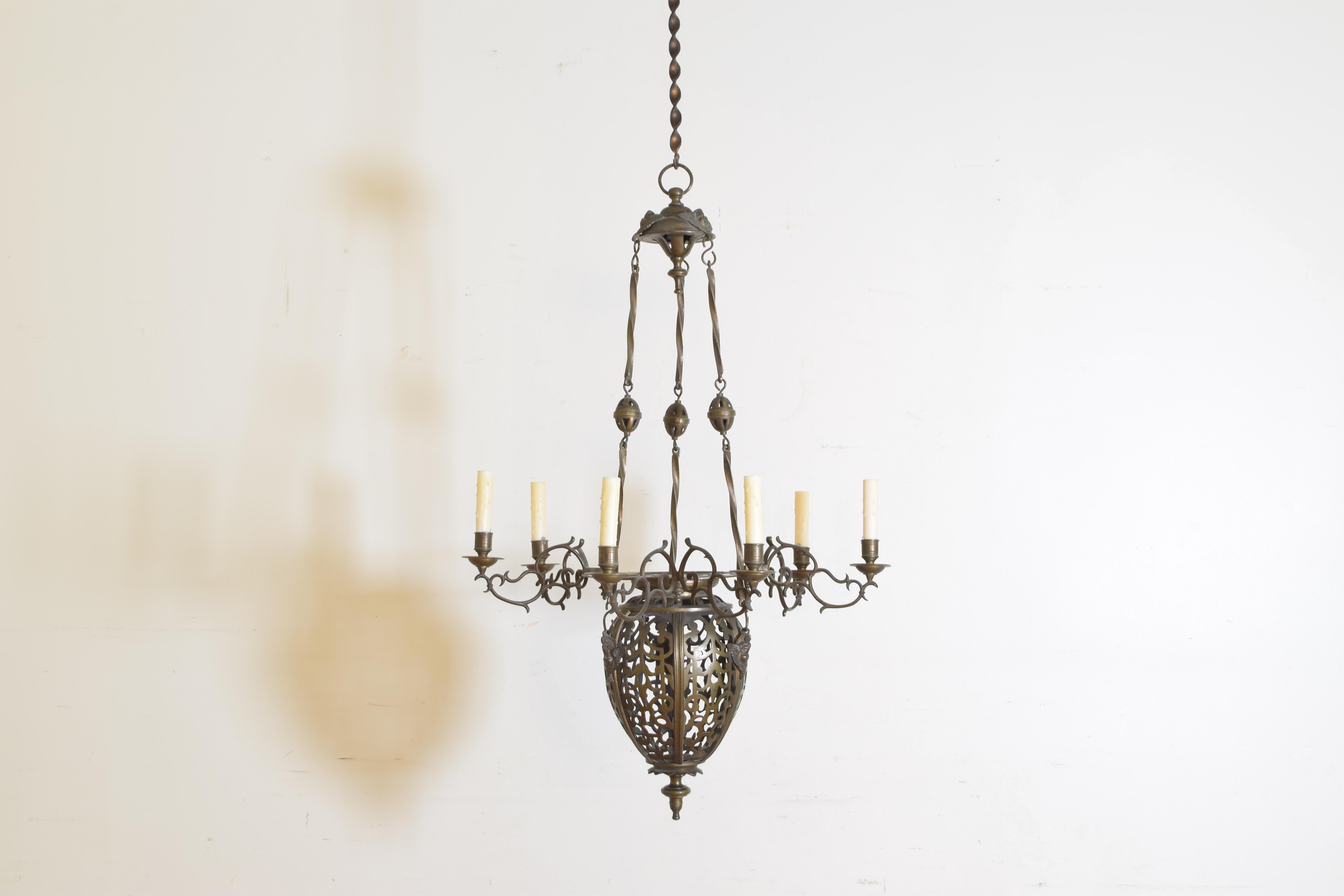 Comprised of an incensiore of pierced bronze, the upper (removable) section a circular pierced bronze flattened disk issuing three arms each with two bobeches, hanging from twisted rods joined by open oval connectors and an original canopy.