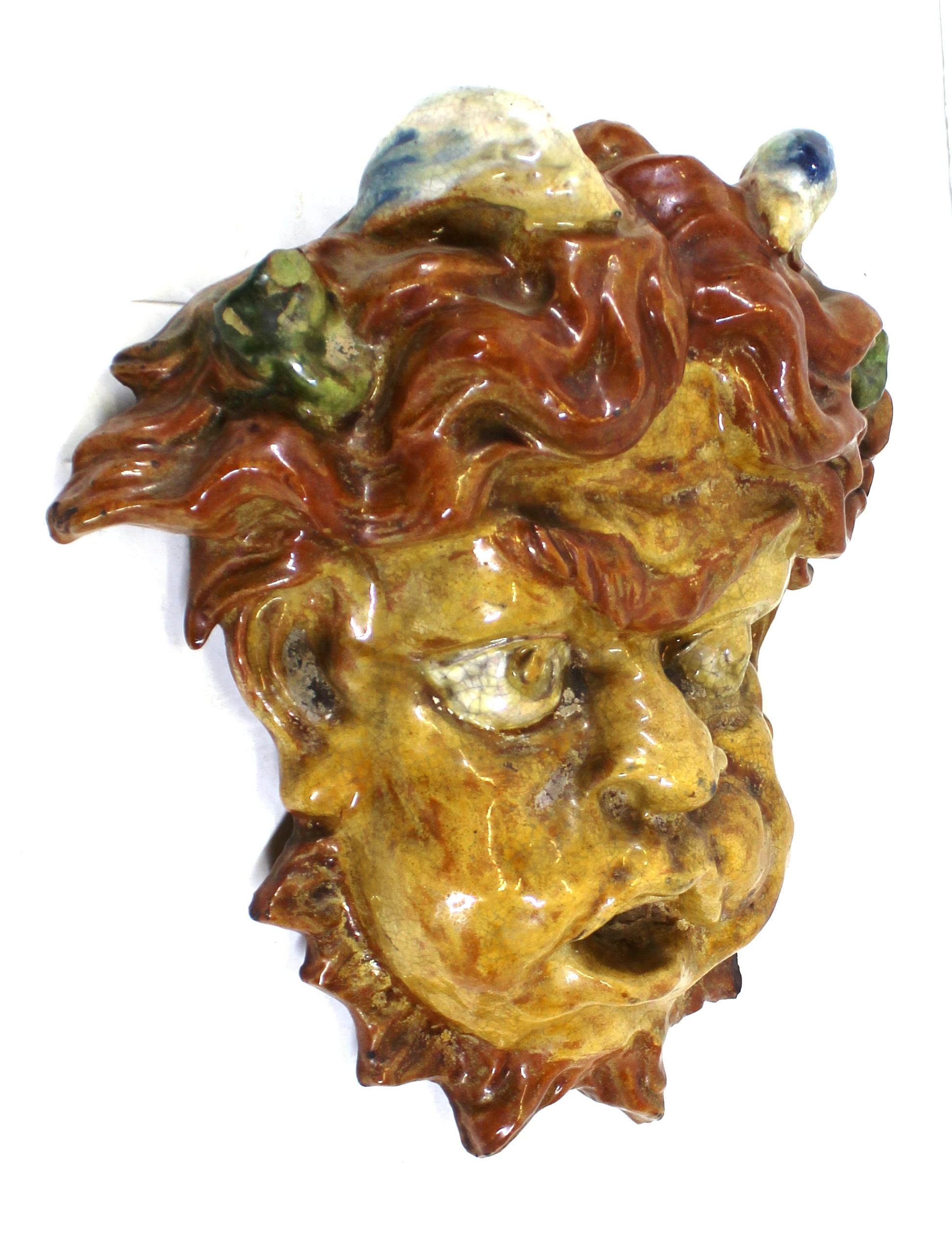 Italian Baroque Revival 19th century puck mask, made in glazed and painted terracotta. The piece can be mounted on a wall. In great antique condition with minor antique repair work.