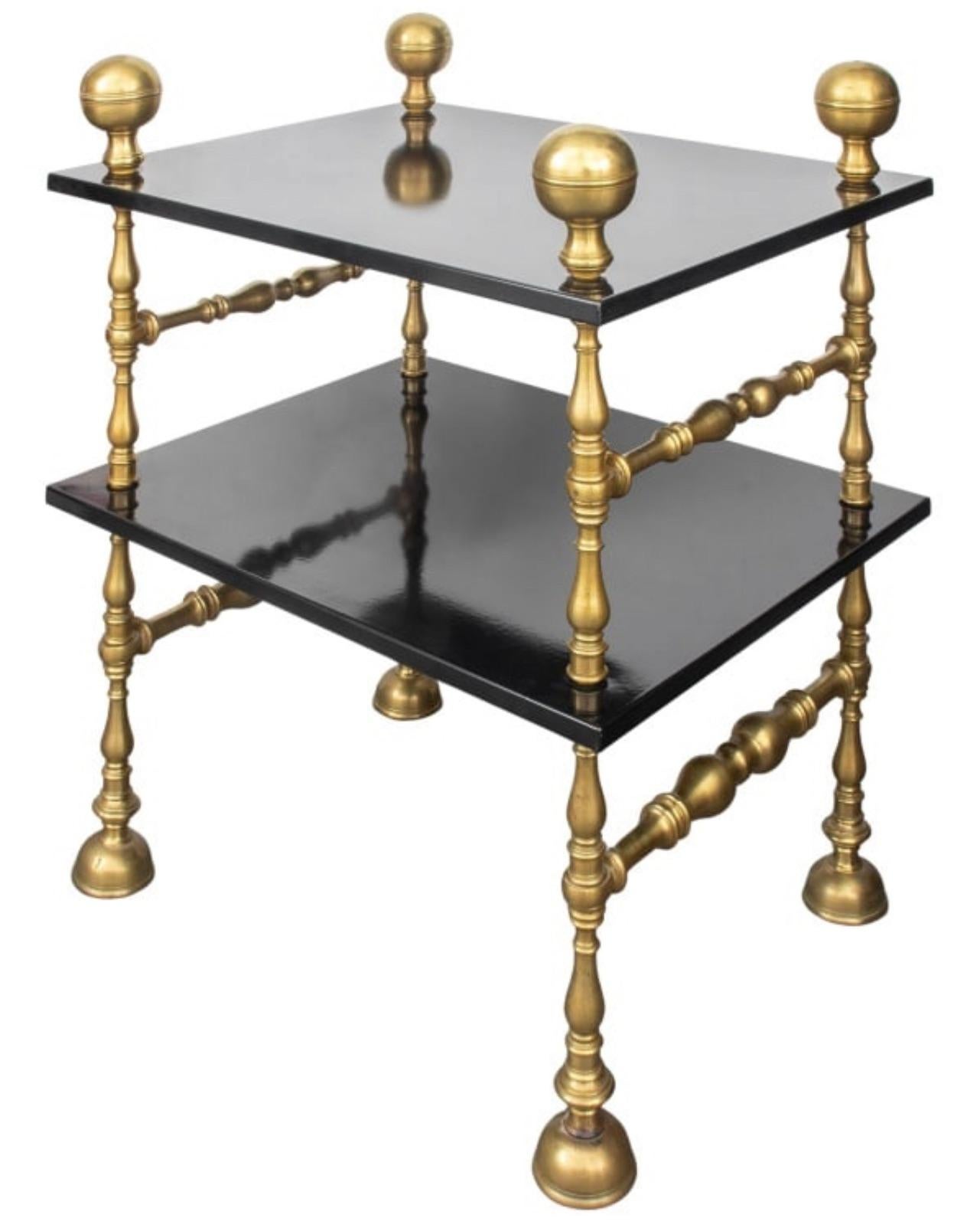 This is a fabulous example of Italian Baroque Revival &  Romanesque style  Brass & Black Lacquer 2 Tier Table..
This table has 2 Black Lacquer wood shelves attached with strong  Brass legs ending with large Brass Balls.
This is a heavy piece of