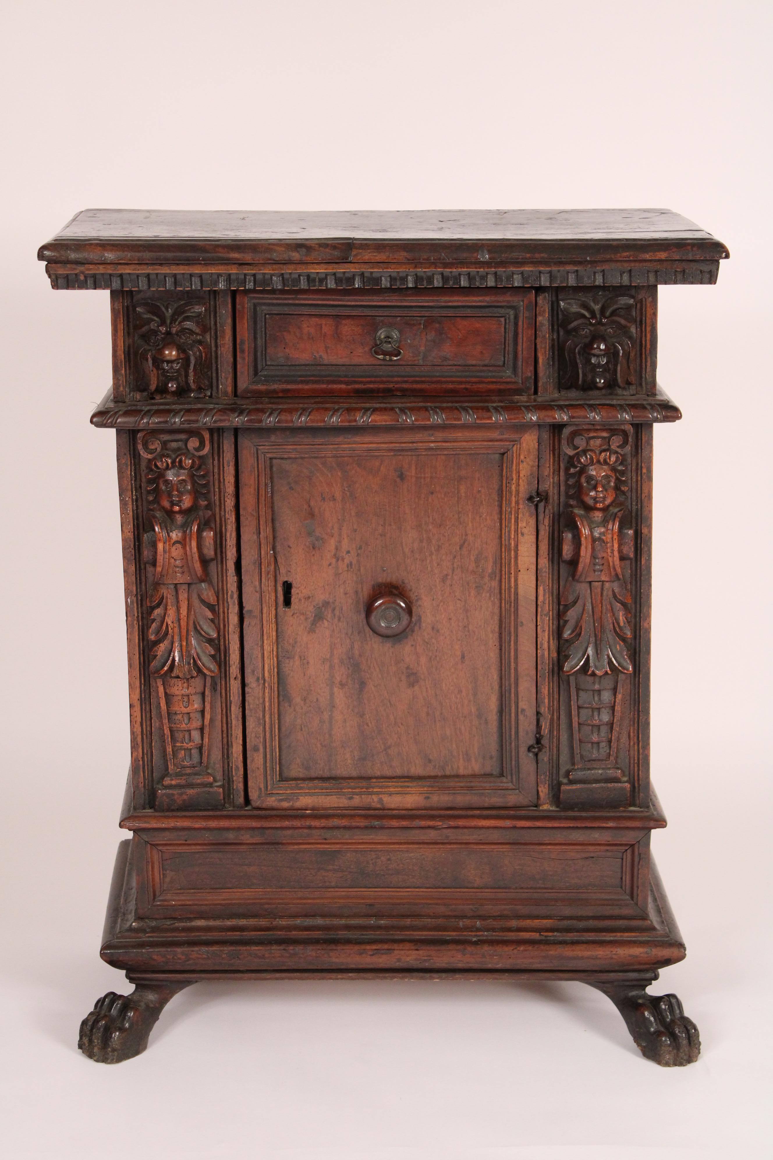 Antique baroque style walnut cabinet, made from antique and later elements probably assembled circa 1920's. With an overhanging rectangular shaped top with front and side molded edges, beneath is dental moldings on front and sides edges, carved