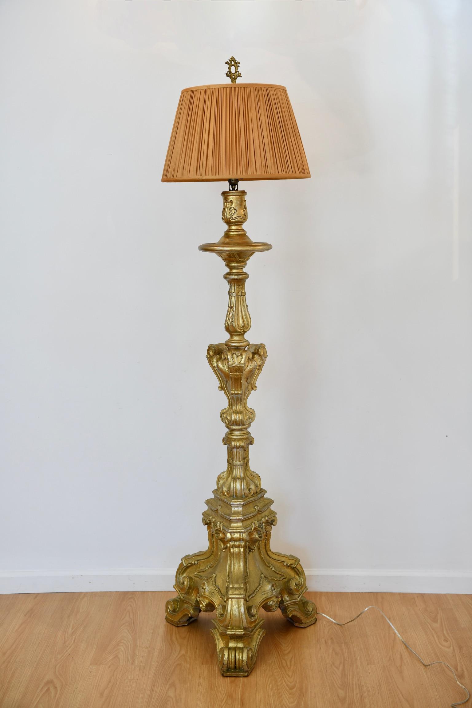 Italian baroque-style carved giltwood floor lamp converted from a pricket candlestick with scrolling and foliate details. Dimensions: 77.5
