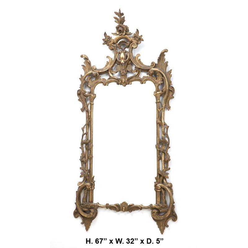 19th century Italian Baroque style carved giltwood mirror. 

The carved floral crest is over two C-scrolls with scrolling acanthus leaves, above a rectangular mirror plate surrounded by intertwined vines and foliage.