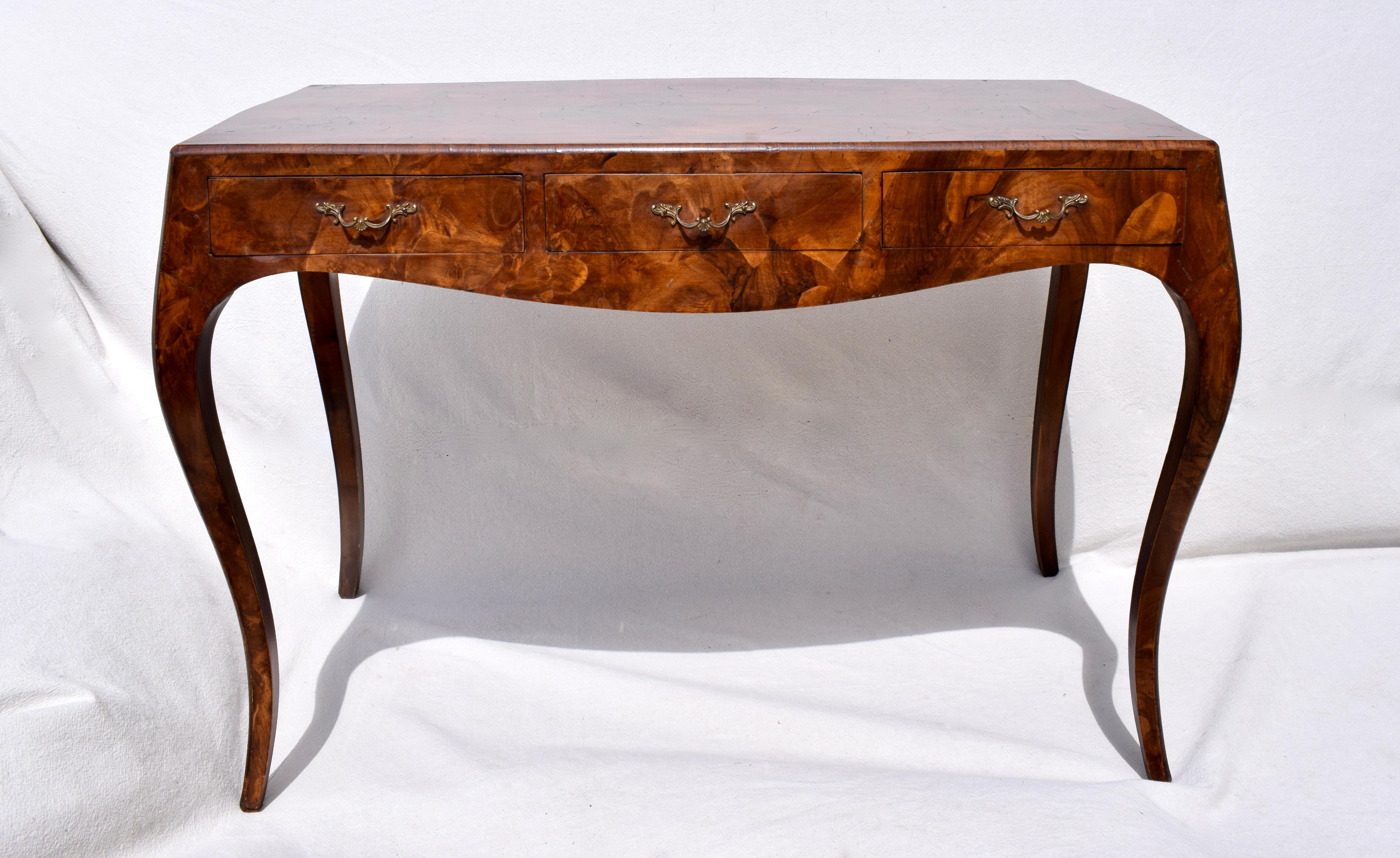 Italian Baroque style oyster burl wood console table with cabriole legs, bombe sides and three drawers. We have intentionally photographed in a variety of natural light settings from clouds to bright sunshine to portray striking variations of the