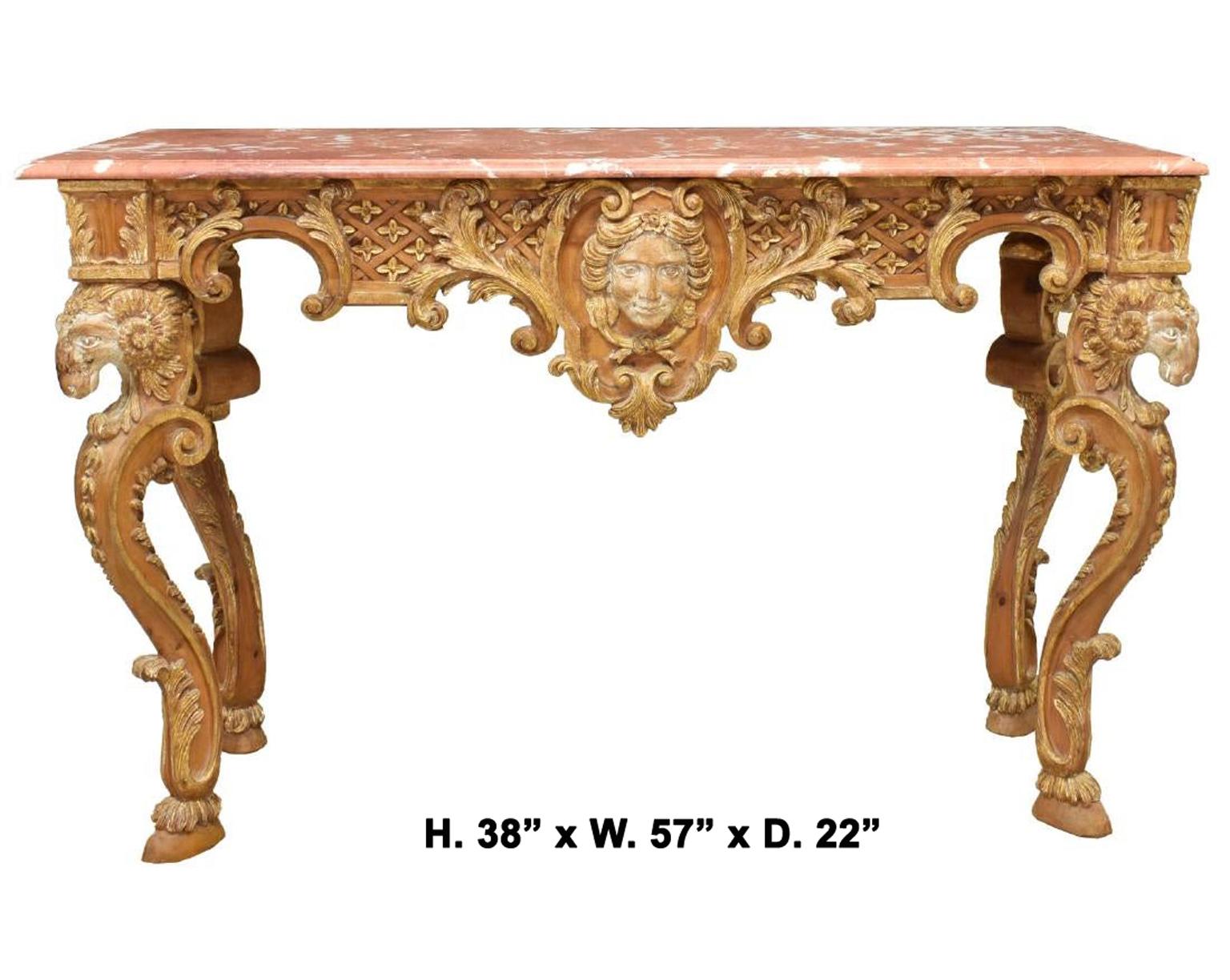 Impressive Italian Baroque style parcel-gilt carved console table with ram's head,
early 20th century.

A moulded rectangular mottled marble top is over a finely carved parcel gilt apron decorated in a latticework and foliate motif, centered by a
