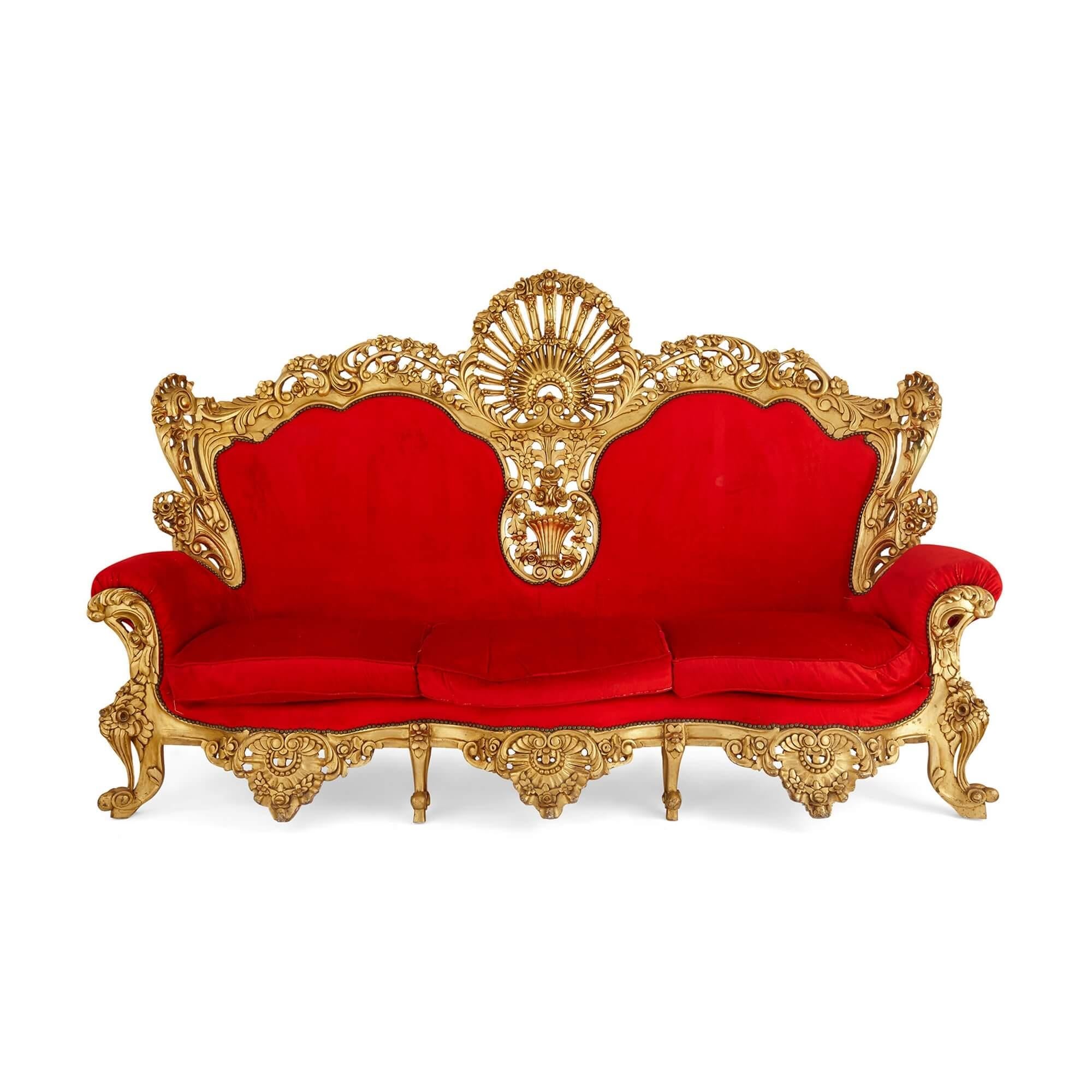 Italian Baroque style three-piece upholstery and giltwood seating suite
Italian, 20th century
Measures: Settee: Height 164cm, width 261cm, depth 84cm
Armchairs: Height 151cm, width 106cm, depth 80cm

This fine suite of furniture is an