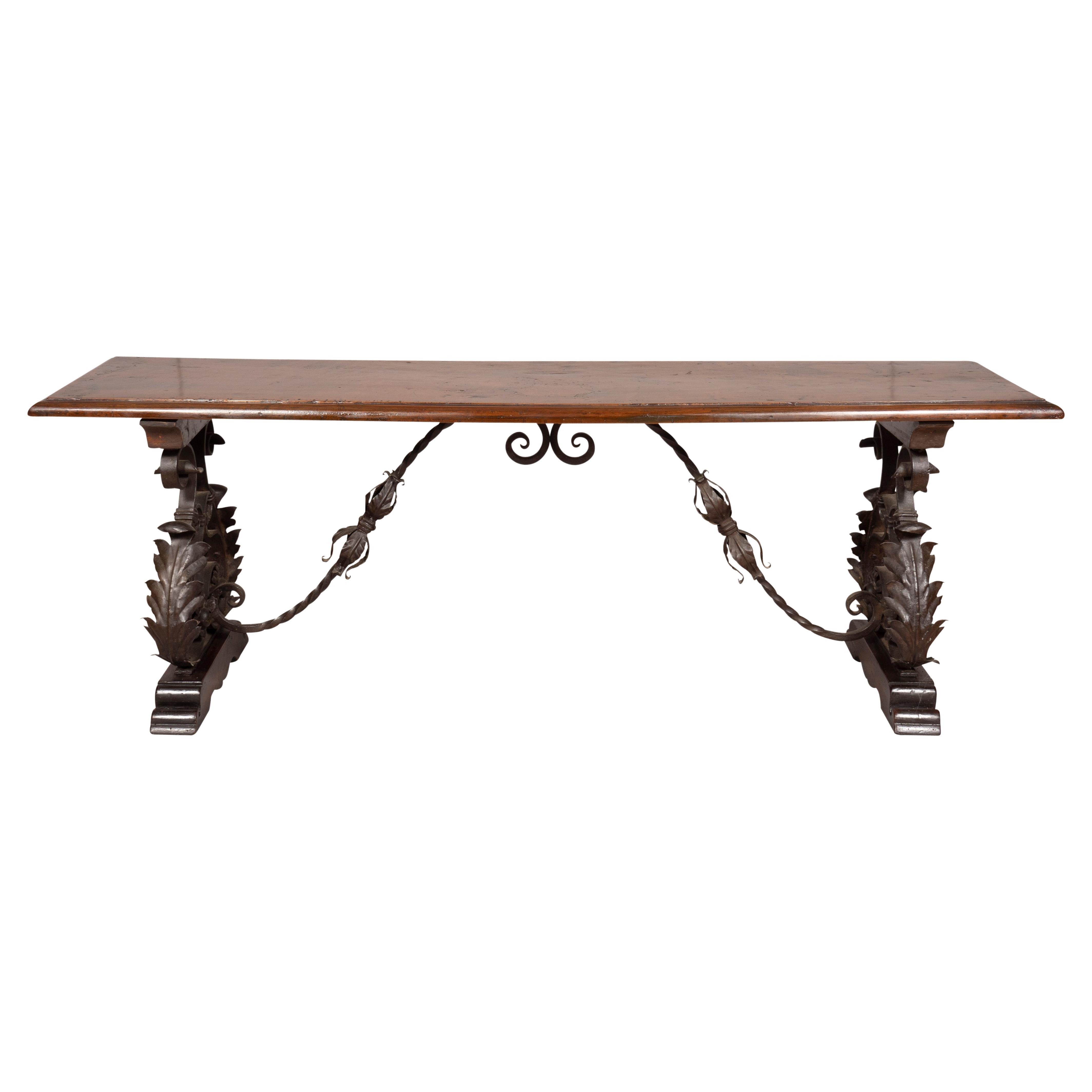 The rectangular top over an elaborate iron base. Consisting of early elements. Great front hall bench.