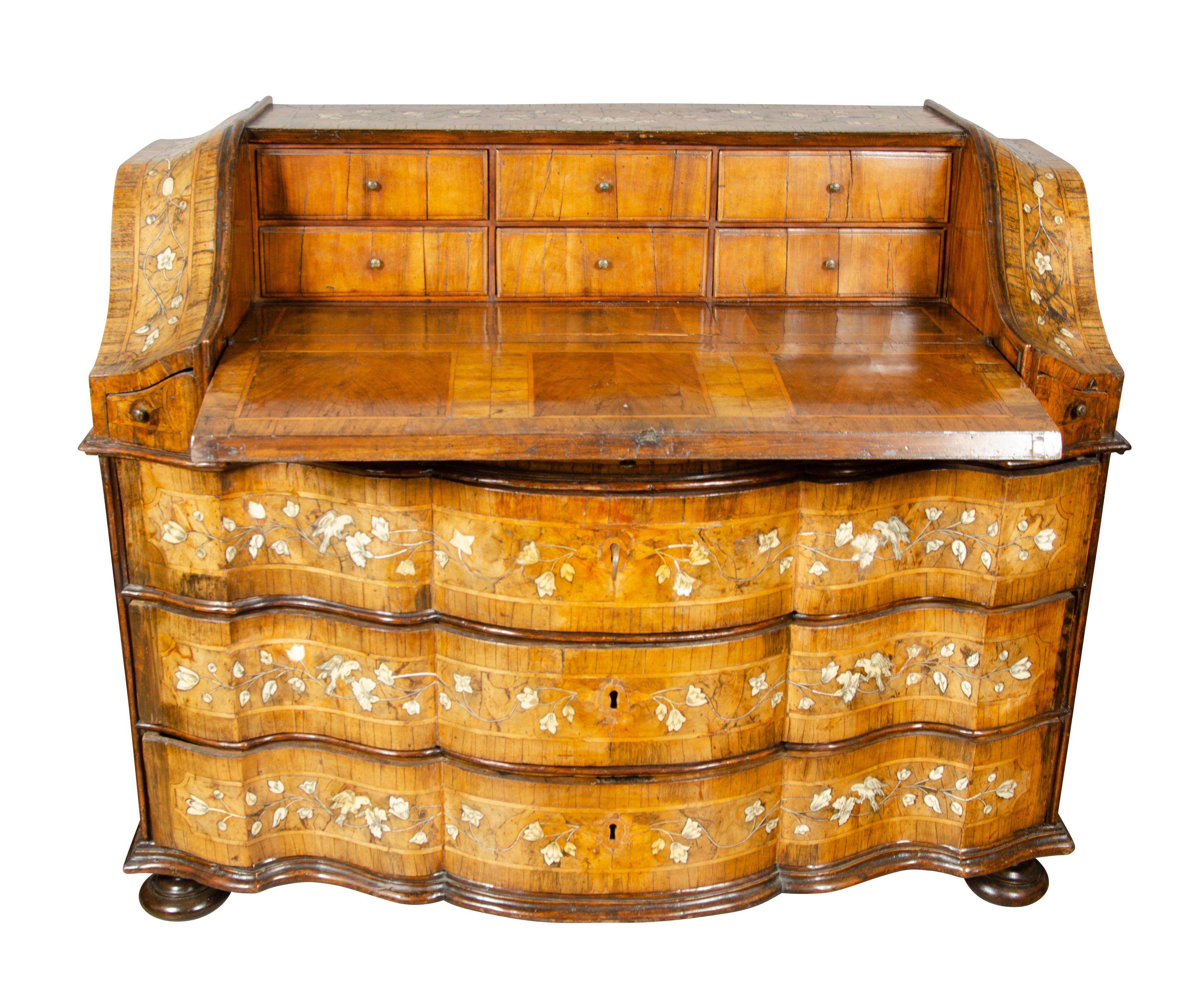 An impressive piece recently purchased from a local family that had it for many years and had inherited it from their grandparents. With rectangular top decorated with trailing flowers and birds over a serpentine slant lid desk section inlaid with