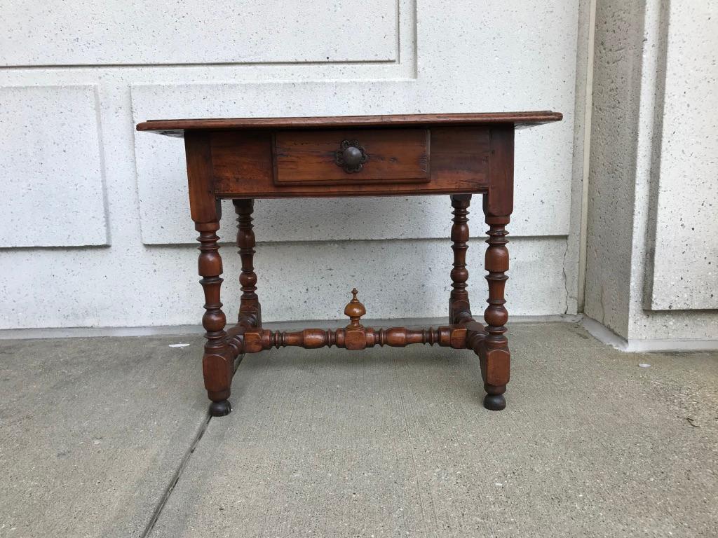 A handsome single drawer side table with beautifully carved and turned walnut base and a chestnut top. Late 17th or early 18th century Italian with a rich and deep honey patina.