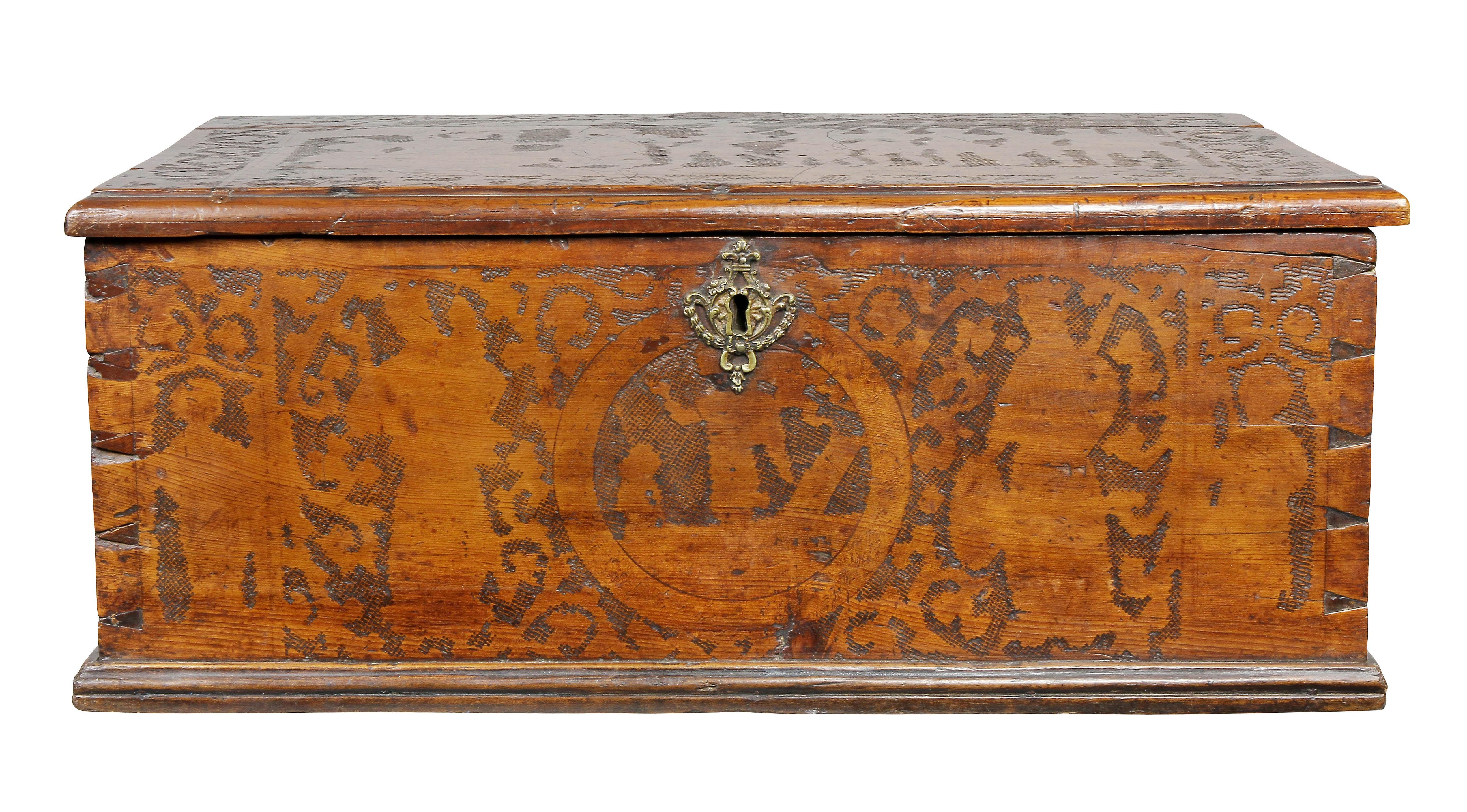 Hinged top, decorated overall with incised carving, lock plate and side handles.