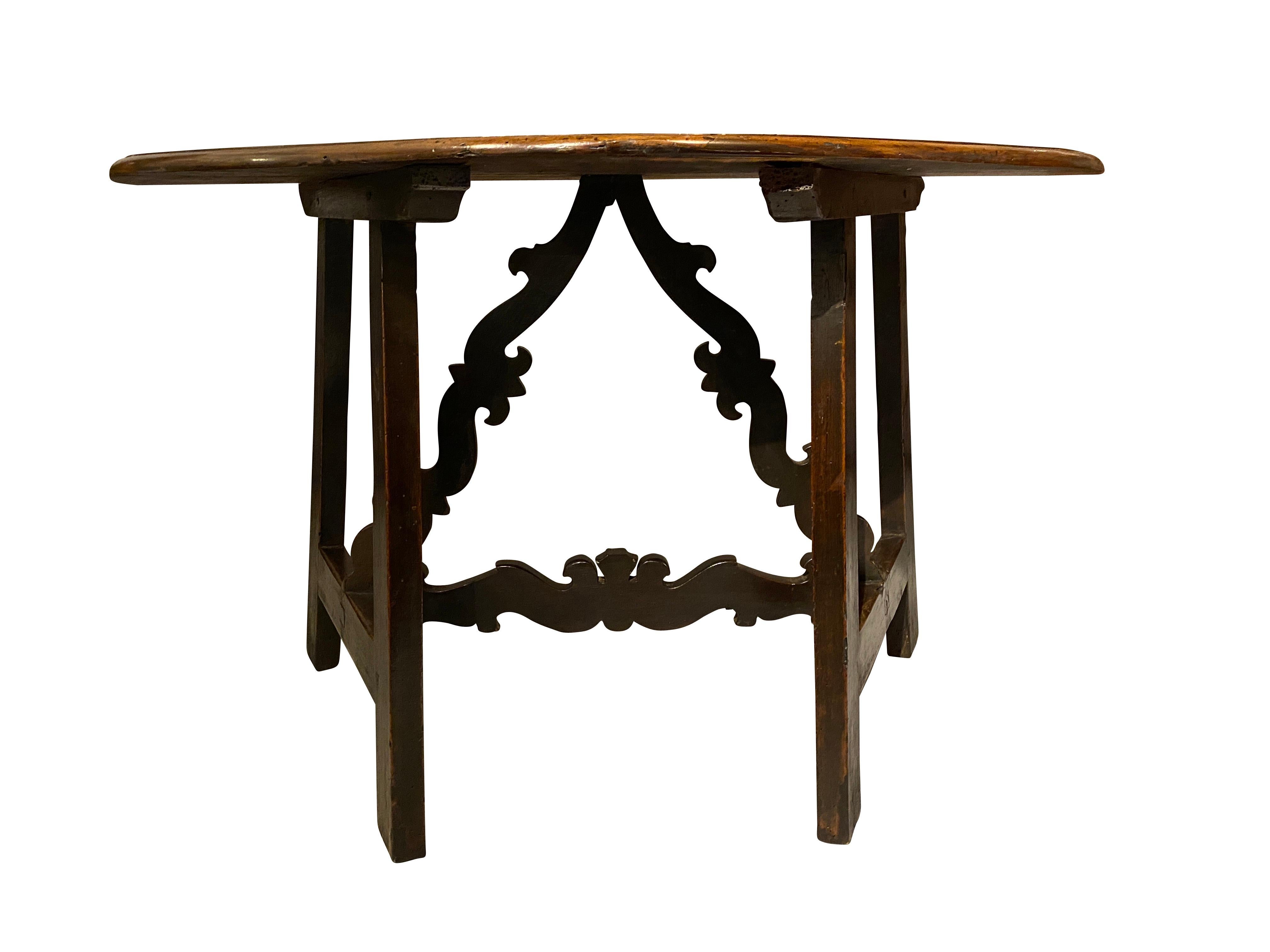 D shaped top with molded edge and great old rich brown patina over square section legs joined by shaped triangular form stretcher.