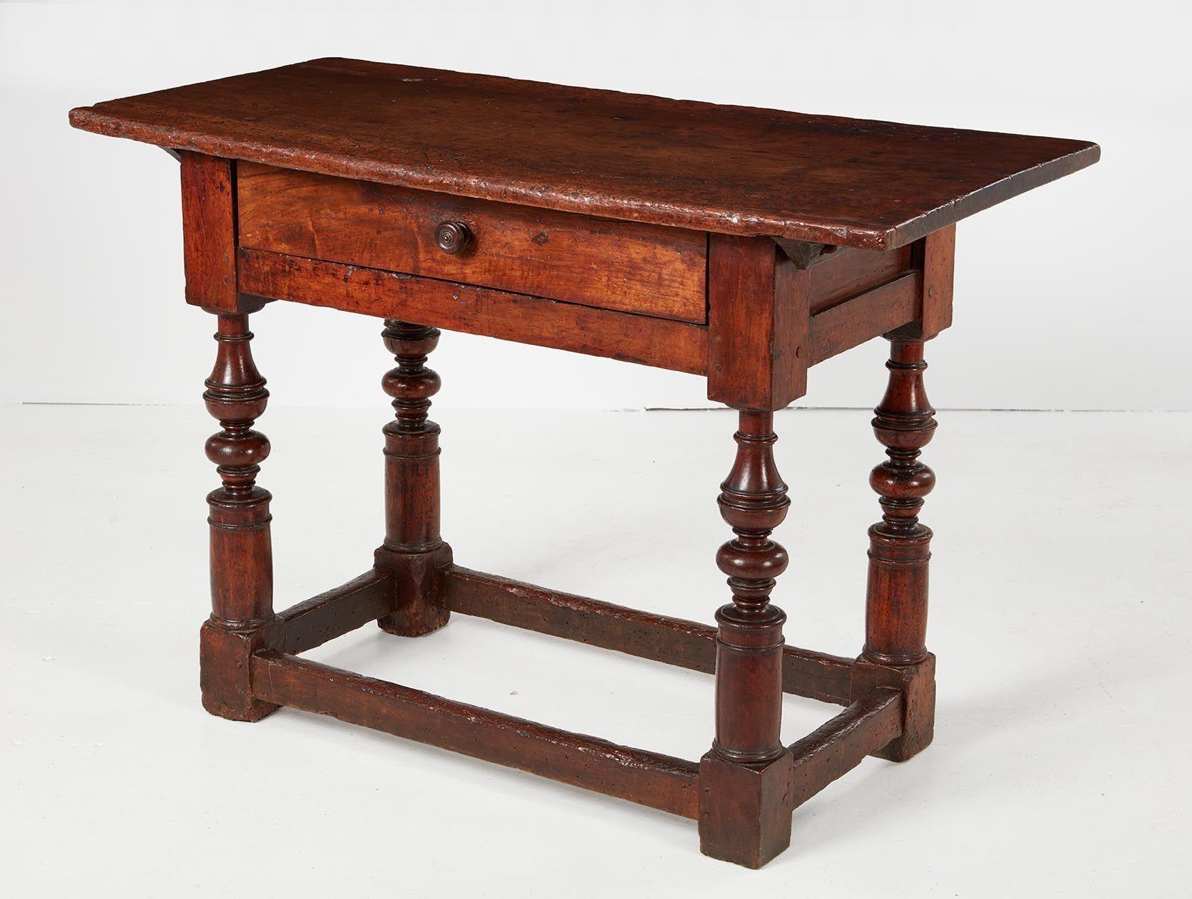 Good 17th Century Italian walnut stretcher base table, the single walnut plank top with dovetailed cleats over single drawer having turned knob and standing on boldly turned legs joined by box stretcher, the whole with good rich color and patination.