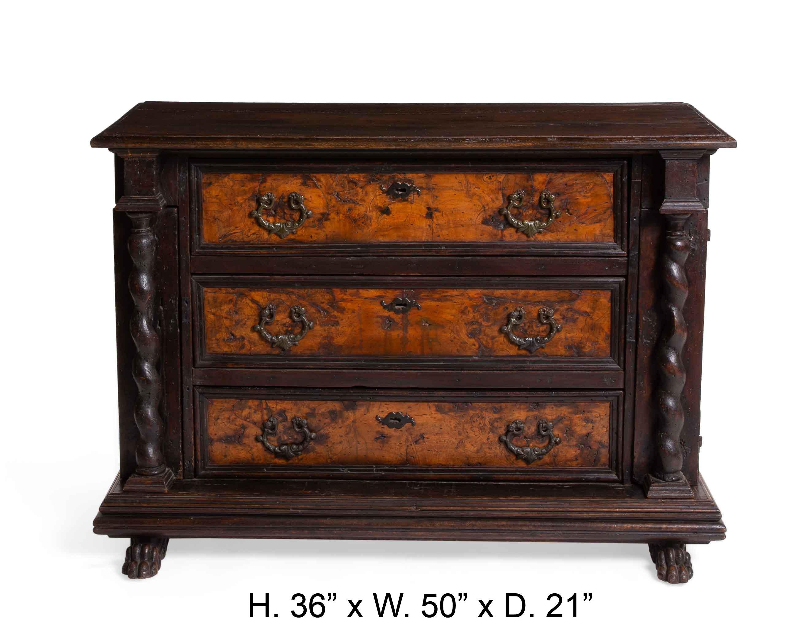 Unique Italian Baroque carved walnut and walnut veneer chest of drawers, late 17th century.
The rectangular walnut top with molded edge above three long drawers, flanked by three small drawers on each side covered by spiral columnar