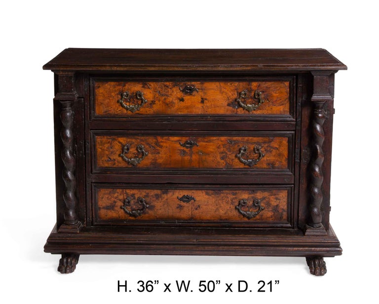 Unique Italian Baroque carved walnut and walnut veneer chest of drawers, late 17th century.
The rectangular walnut top with molded edge above three long drawers, flanked by three small drawers on each side covered by spiral columnar