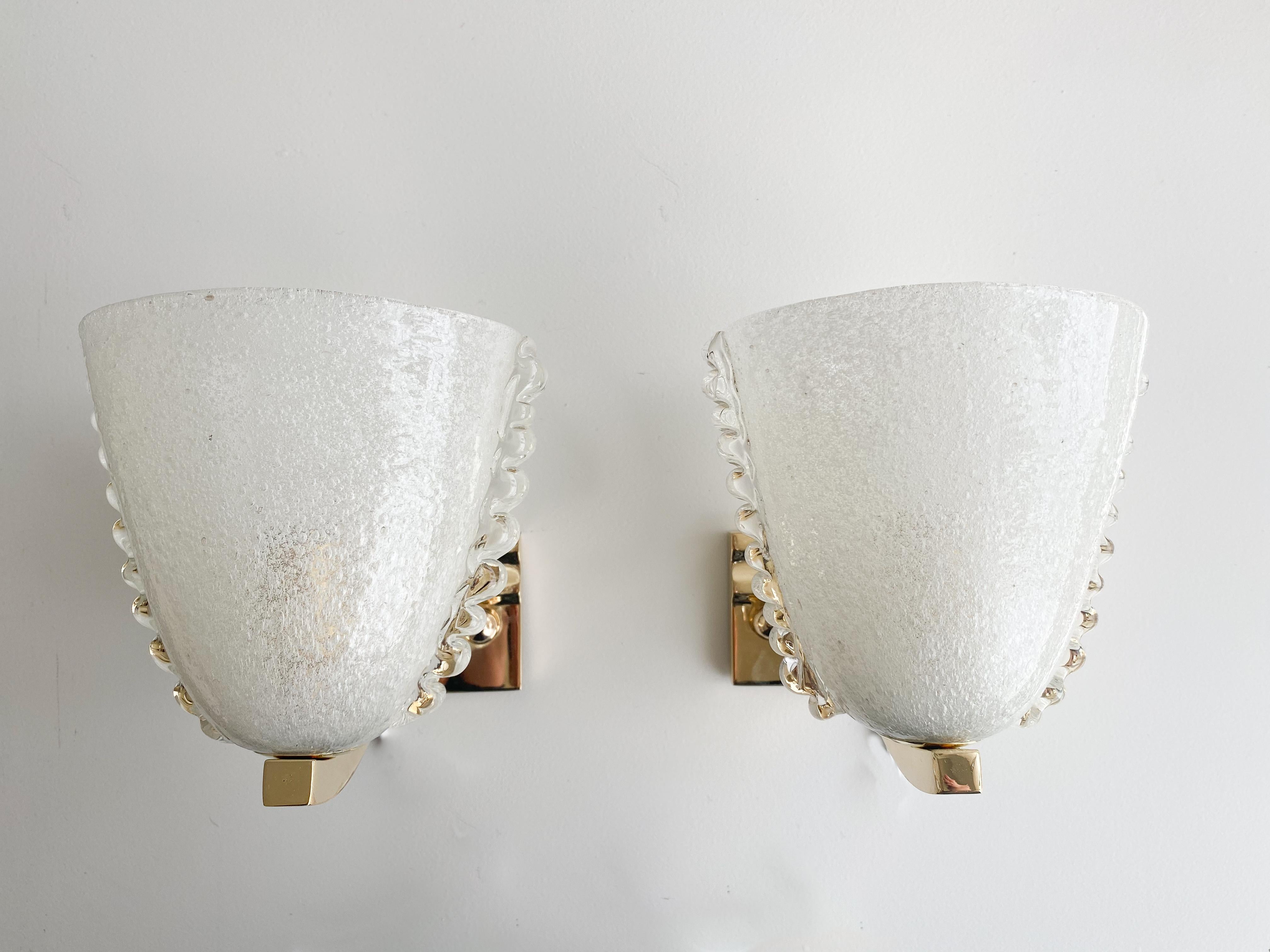 Beautiful pair of Italian glass sconces by Barovier. Frosted glass with scalloped glass side detail. Brass fixture has been newly plated in unlacquered brass. Each sconce has a single socket and has been newly rewired. 


  