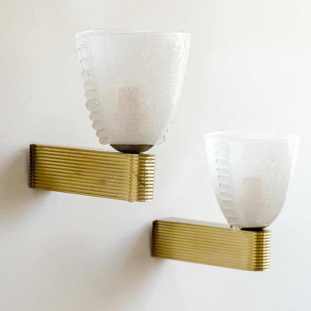 Beautiful pair of Italian glass sconces by Barovier. Frosted glass with scalloped glass side detail. Curved brass fixture with ribbed detailing. Each sconce has a single socket and has been newly rewired. 



