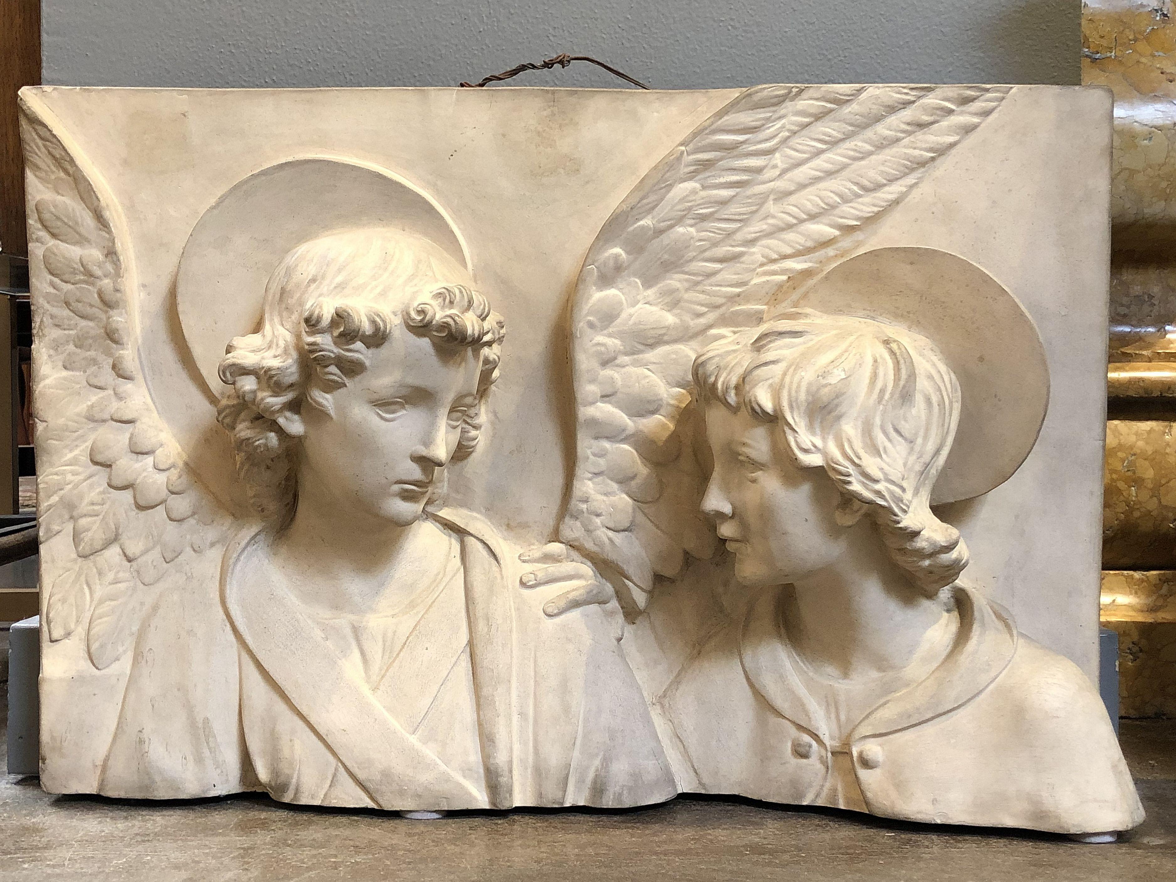 A beautiful Italian bas-relief plaque of terracotta in the manner of Della Robbia, cast as the heads of an angel and a saint
Each figure in religious costume, the angel with wings and the saint with halo.

With impressed mark from one of the
