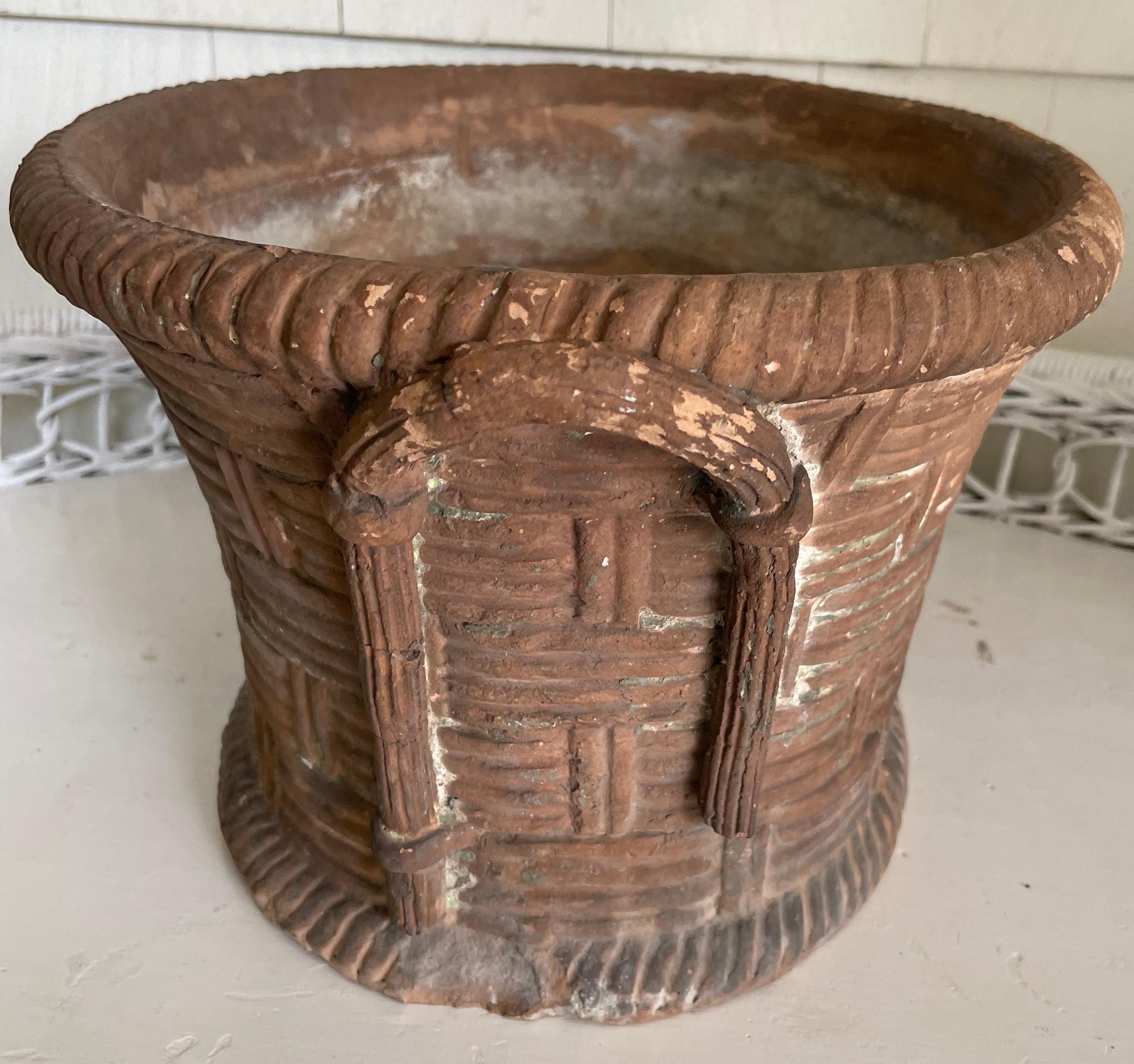 Italian basket weave terracotta planter.   Neoclassical period antique cachepot planter beautifully rendered in terracotta with realistic branch handles; Naples, of the period. Italy, early 1800’s. Dimensions: 15.5