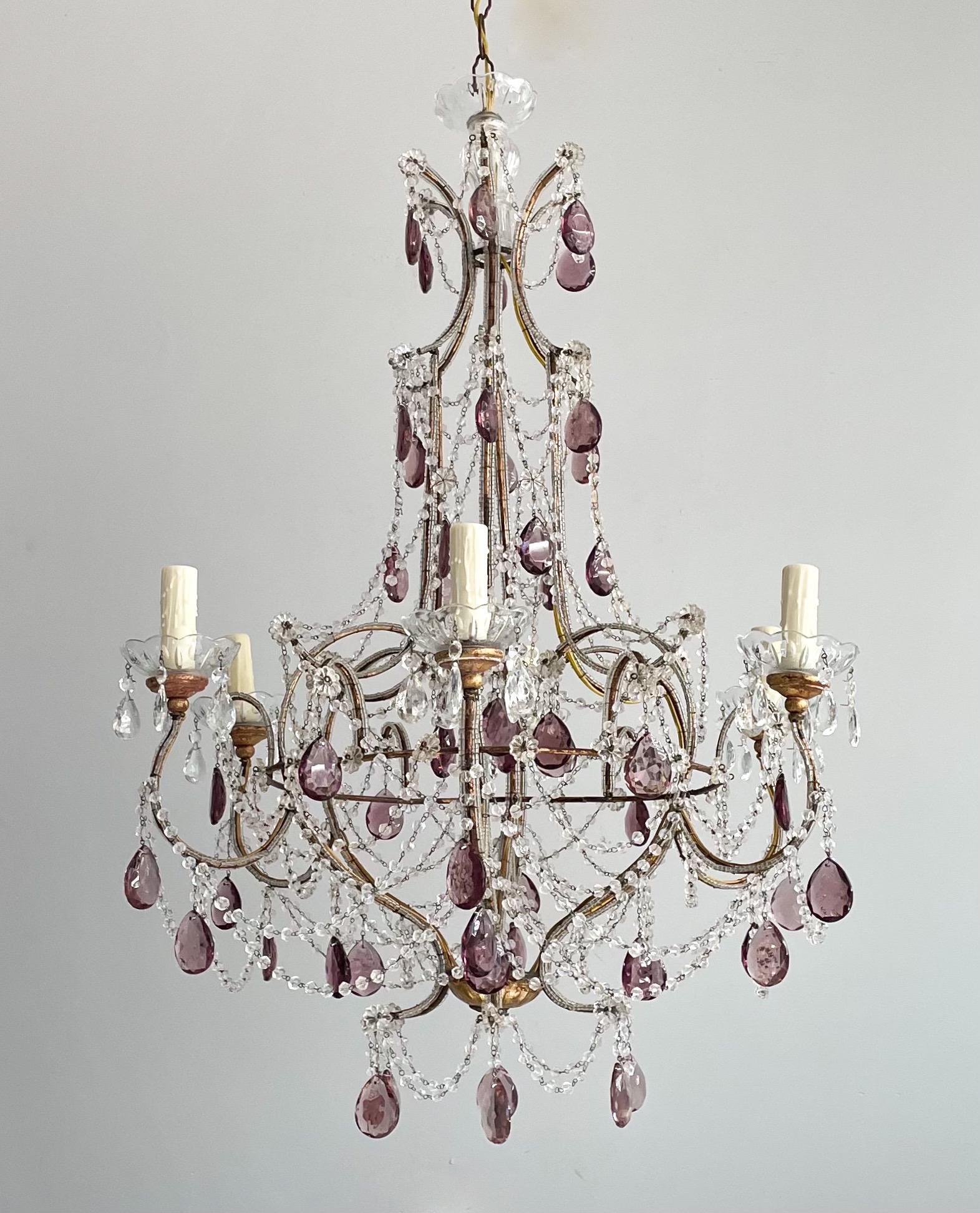 Outstanding, 1940s Italian gilt-iron and crystal beaded chandelier. 

The chandelier consists of a shapely gilded iron frame with glass beading. Beautiful faceted glass prisms in shades amethyst and garlands of “English cut” beads complete the