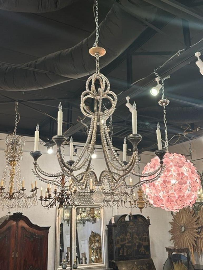 Decorative Italian beaded crystal chandelier with silver gilt and 8 lights. Nicely curved base that creates a light and airy feel.  Pretty!!