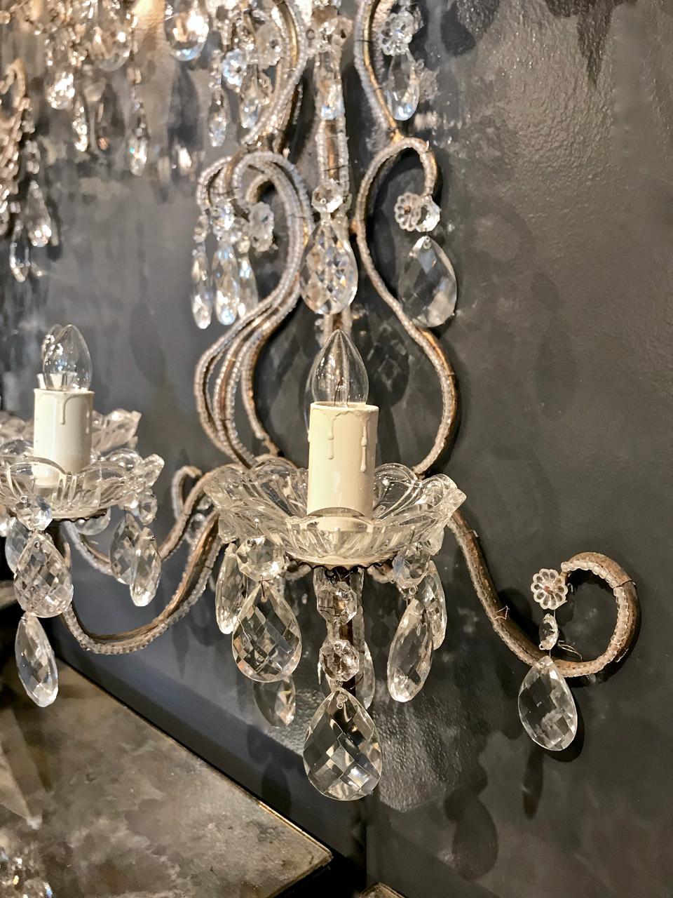 This is a charming single Maria Teresa-style Italian beaded sconce that dates to the 1950s. The sconce is detailed with an abundance of faceted drop pendants. The arms retain their original gold leaf and are highlighted with two rows of beading. The