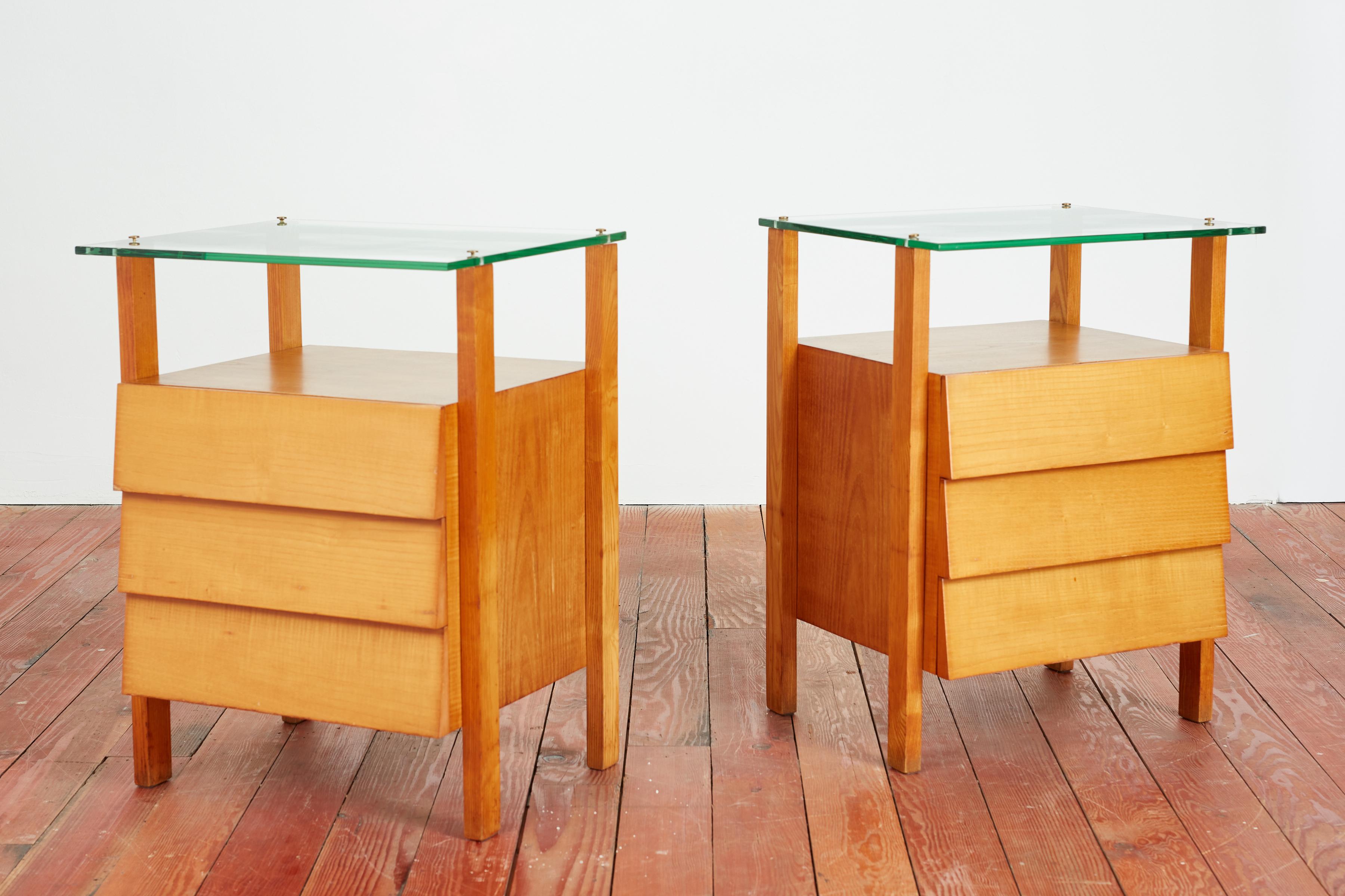 Wonderful pair of Italian bedside cabinets with floating glass top and 3 drawers 

Italy, 1950's 

Solid construction with original rich patina 

Large in scale 